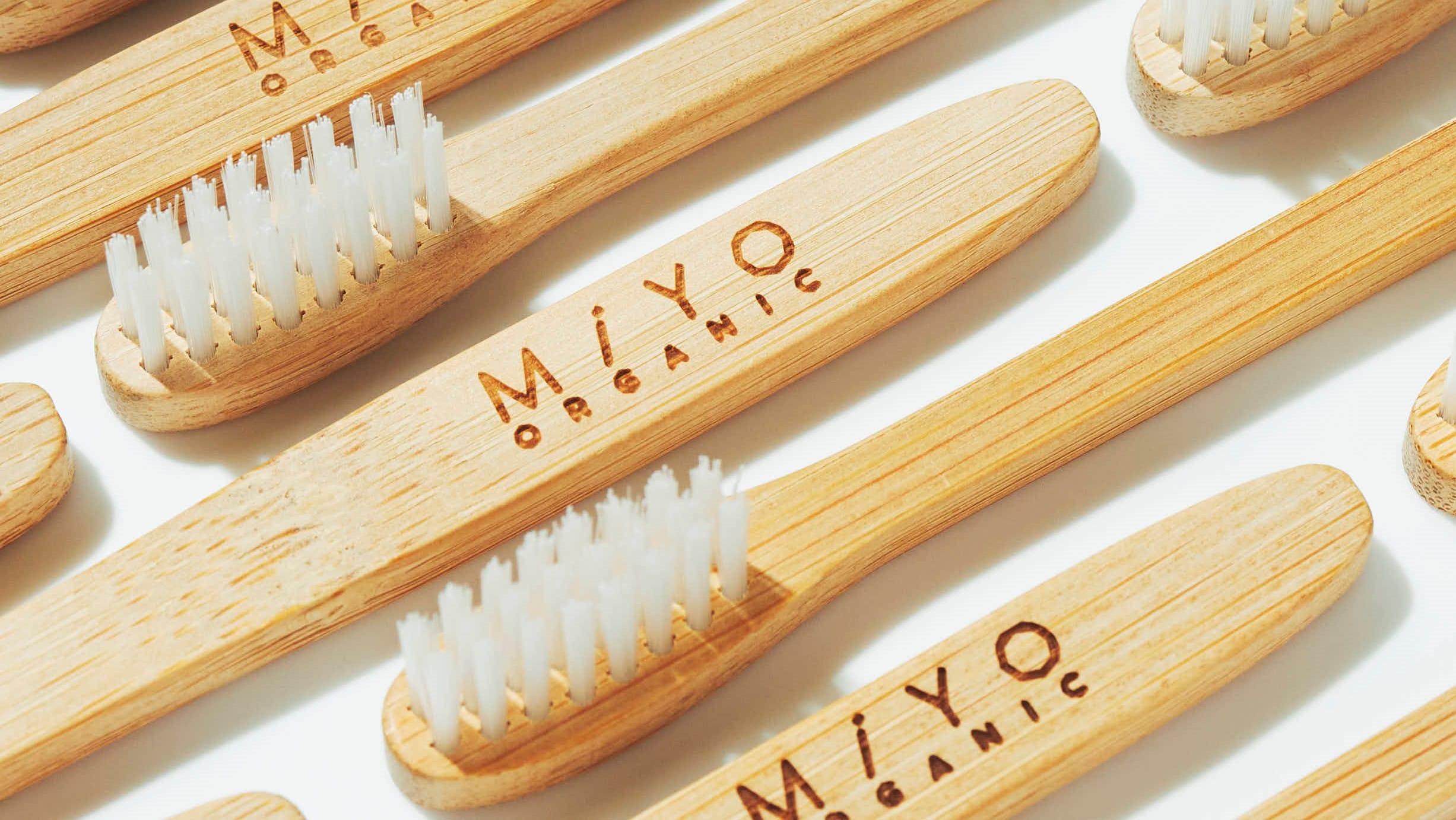 Bamboo toothbrushes made by MiYO ORGANIC. They are available for purchase at the front desk as well as through our sustainable plan.