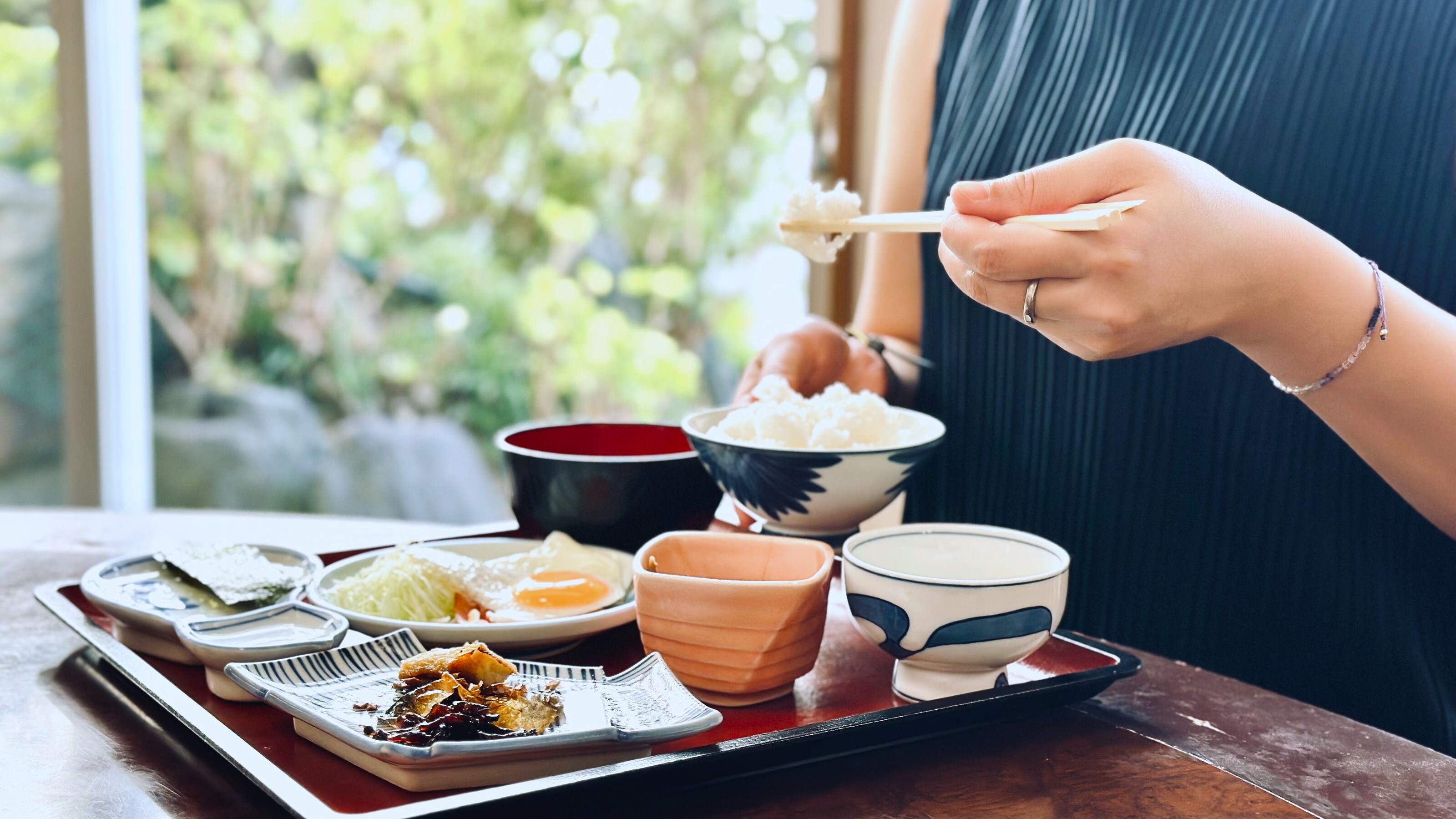 A typical Japanese set meal of rice, eggs, miso soup, and fish