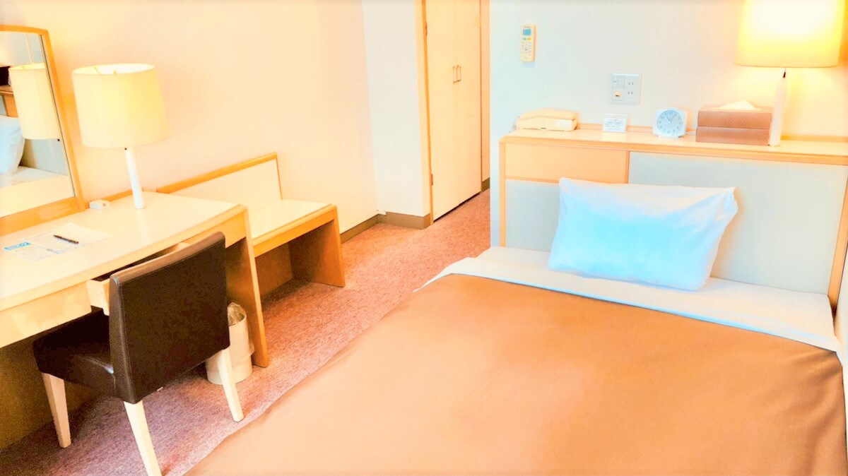 The single room is spacious with a semi-double bed.