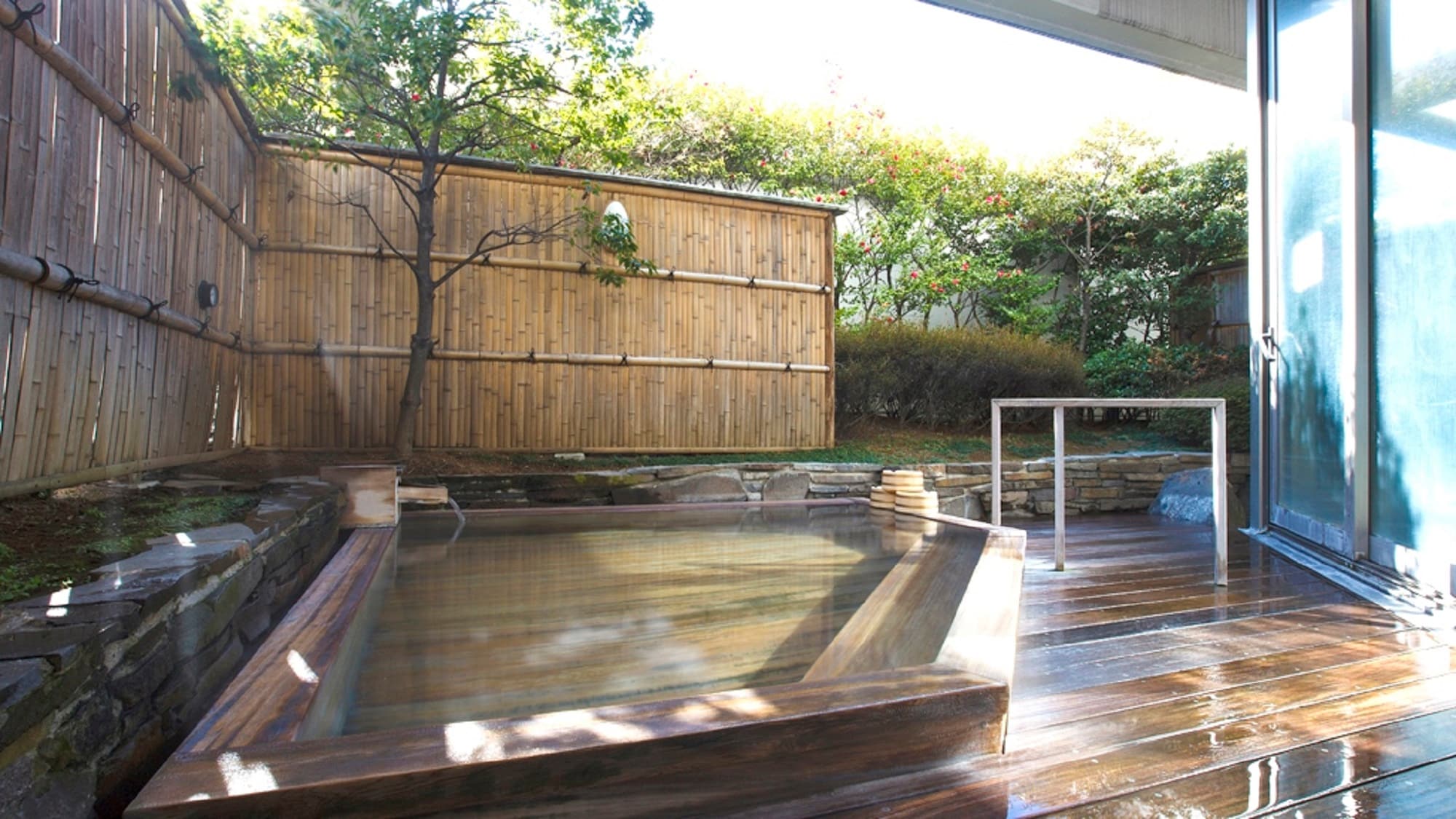 An open-air bath with bright sunlight