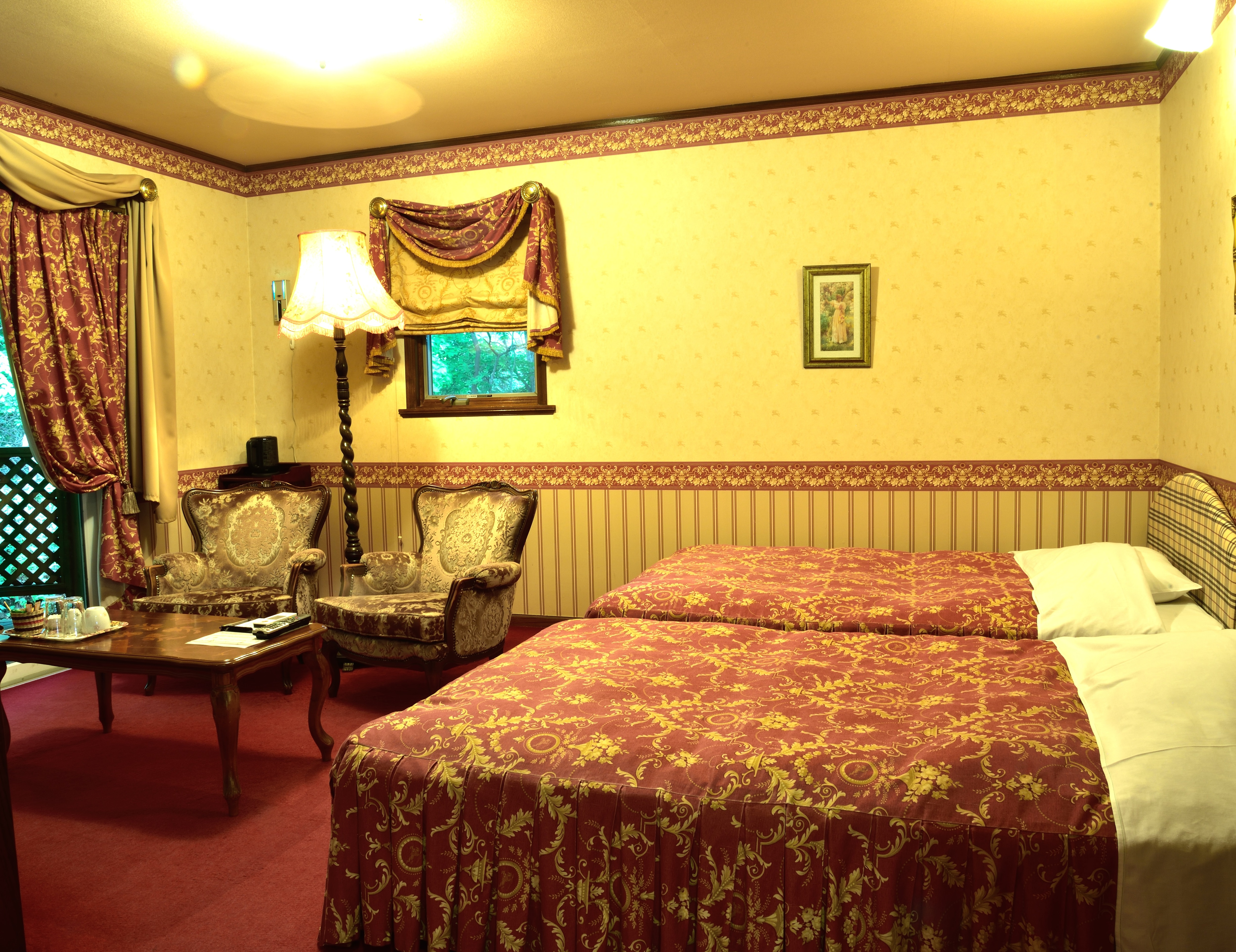 The bed and relaxation space seen from the entrance of Room 110.