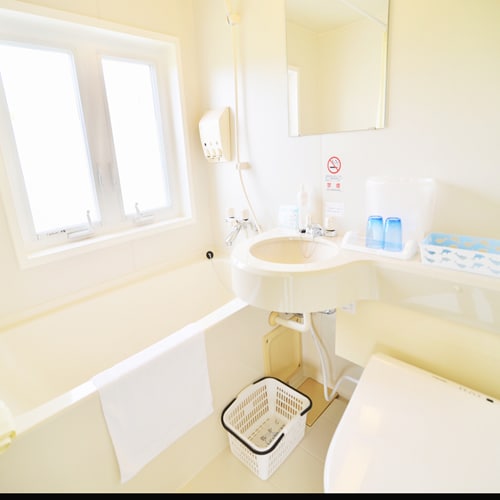 [Example of a twin room with balcony on the second floor facing the ocean] The bathroom has a window, so it's very bright and you can feel the ocean and the sea breeze.