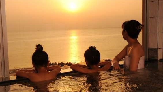 Watch the sunset from the large communal bath