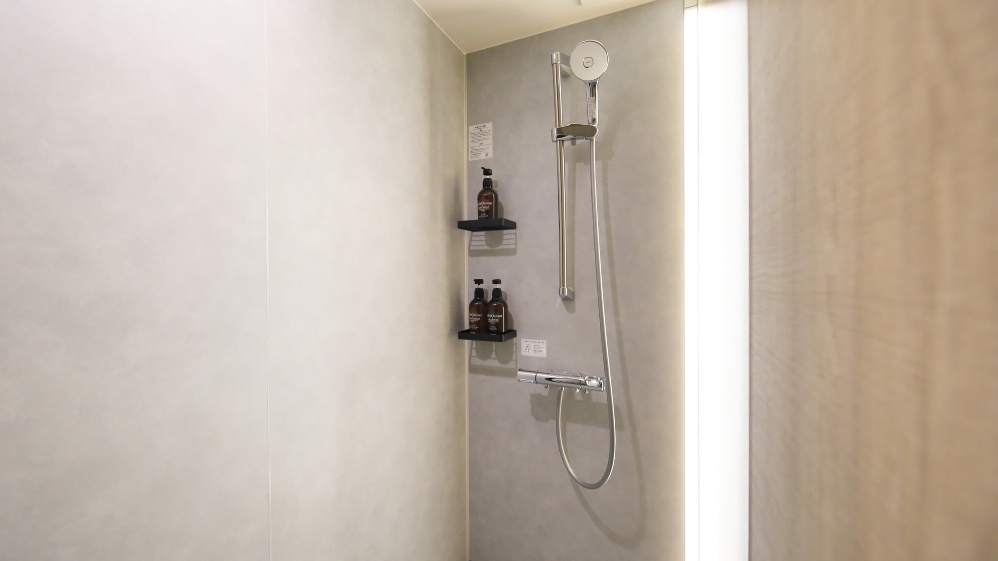 [Renovated West Wing Guest Room] A calming shower booth with a focus on light