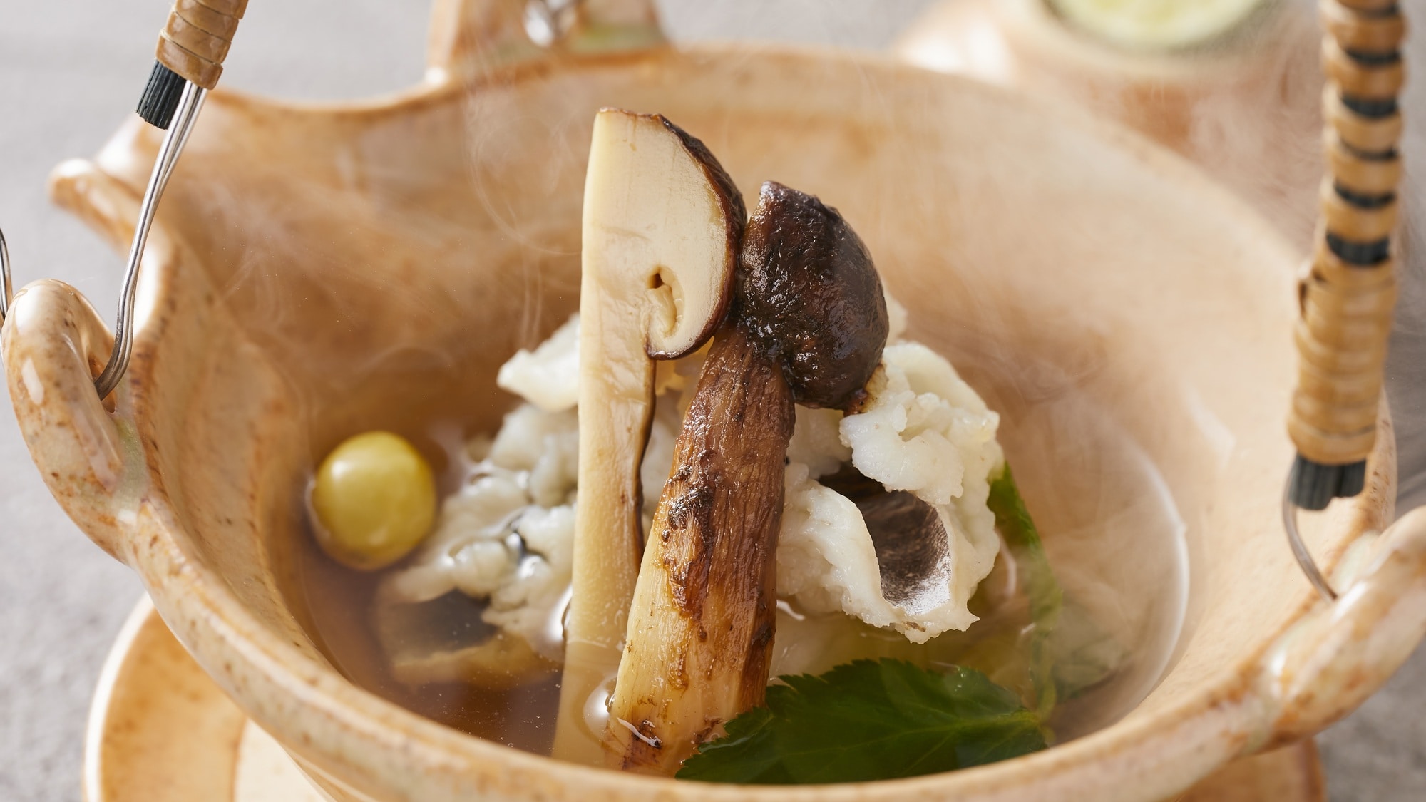 Matsutake mushrooms in a clay pot