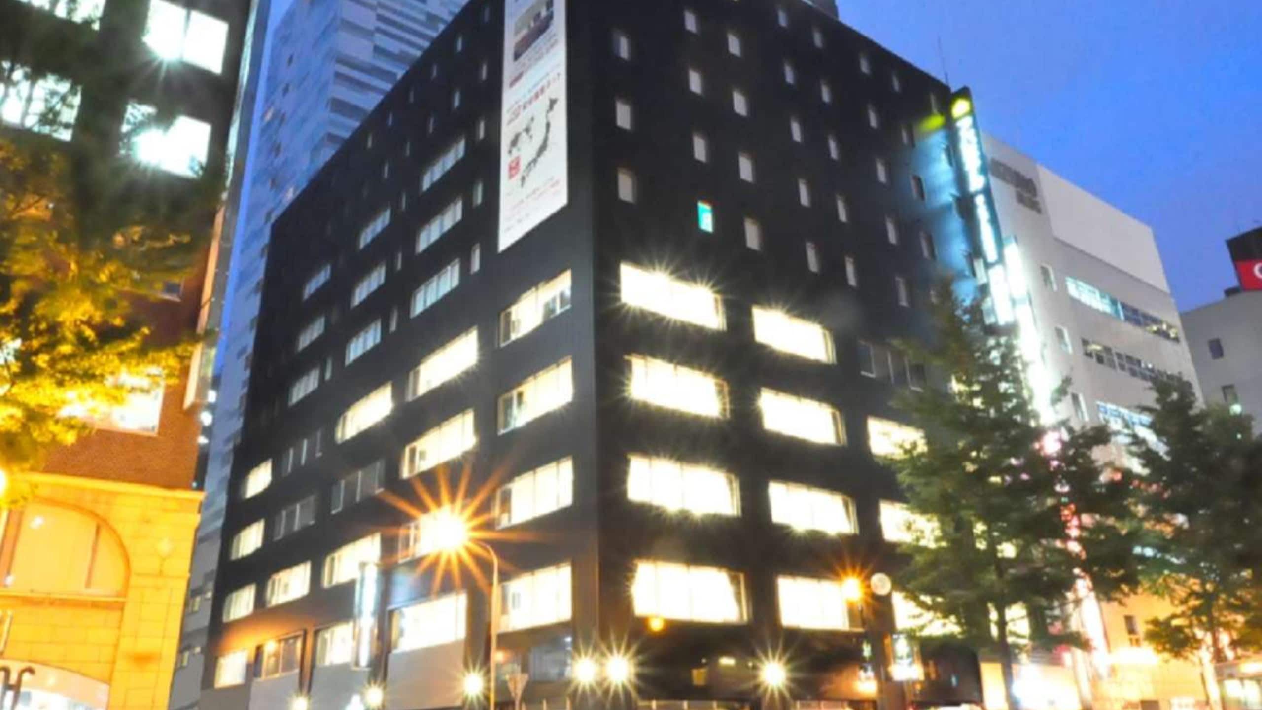 [Hotel exterior at night]