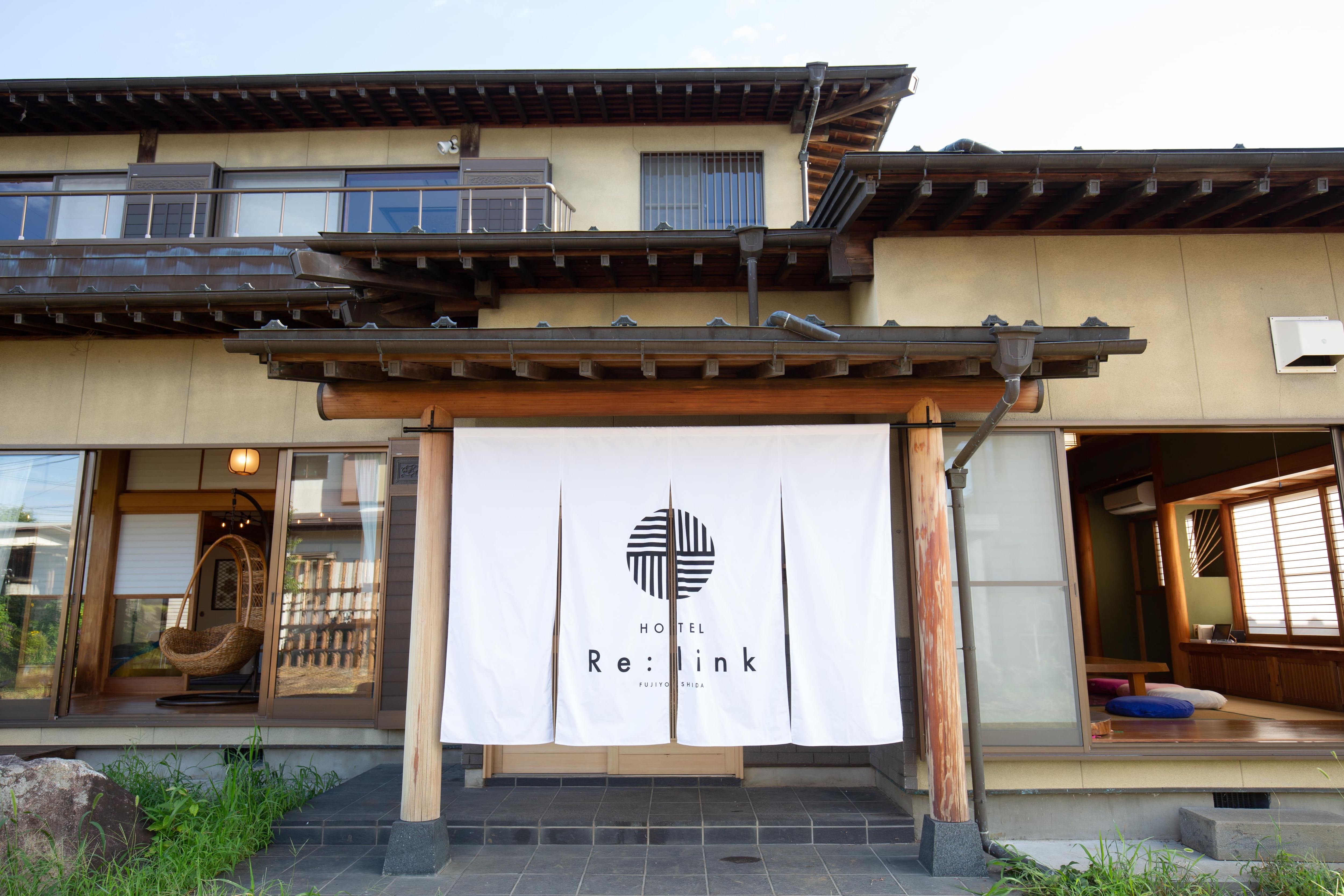 The hotel's main entrance is marked by a noren curtain.