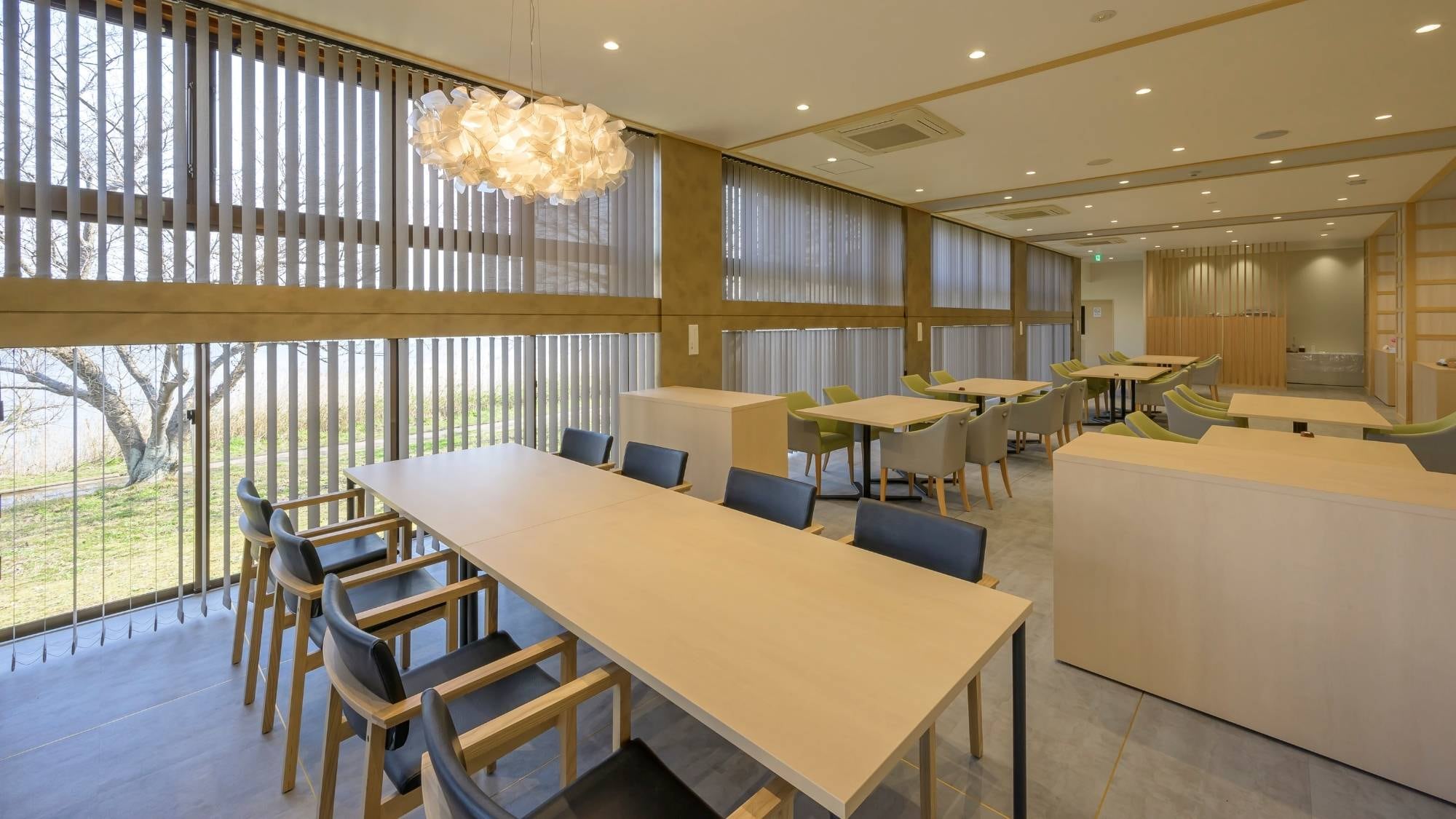 The restaurant has a modern atmosphere with soft colors, and the space is open and refreshing.