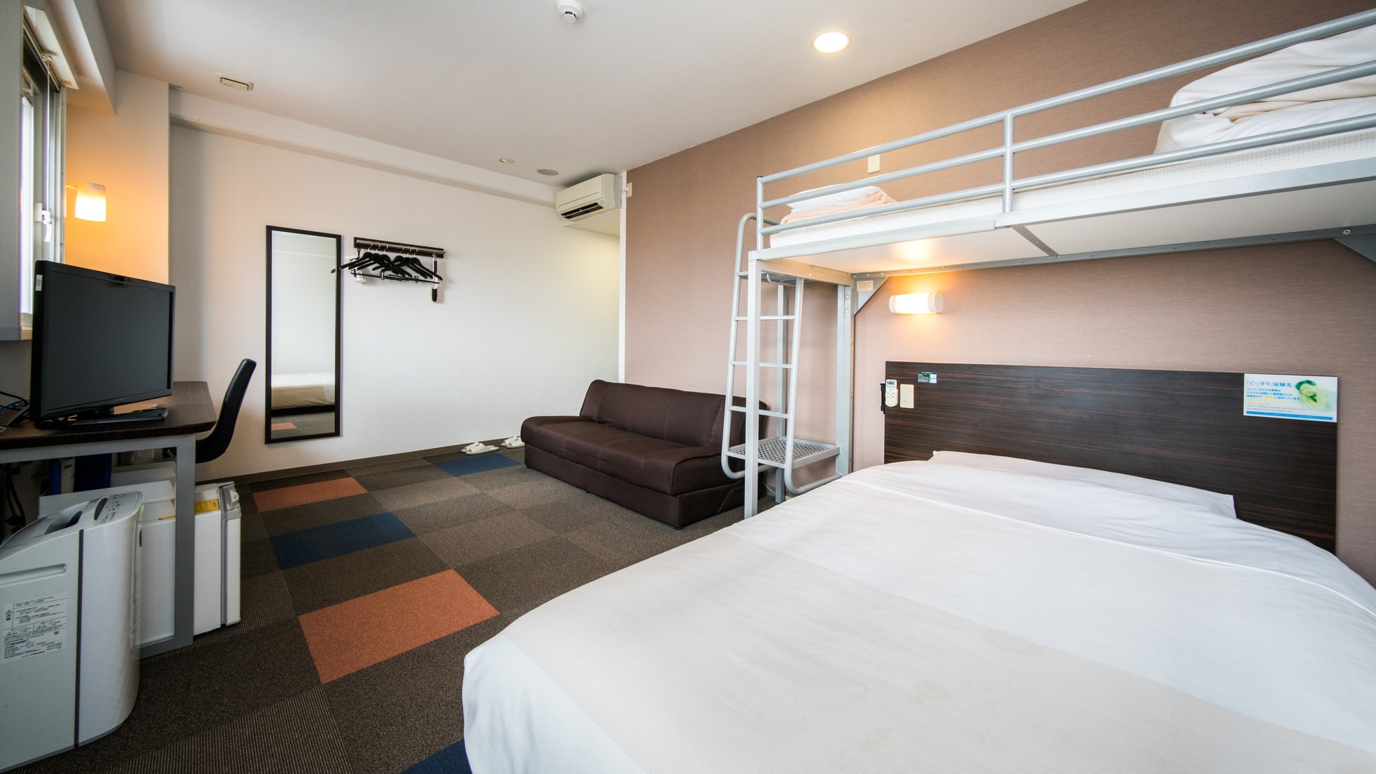 A triple room with a double bed, loft bed and sofa bed.