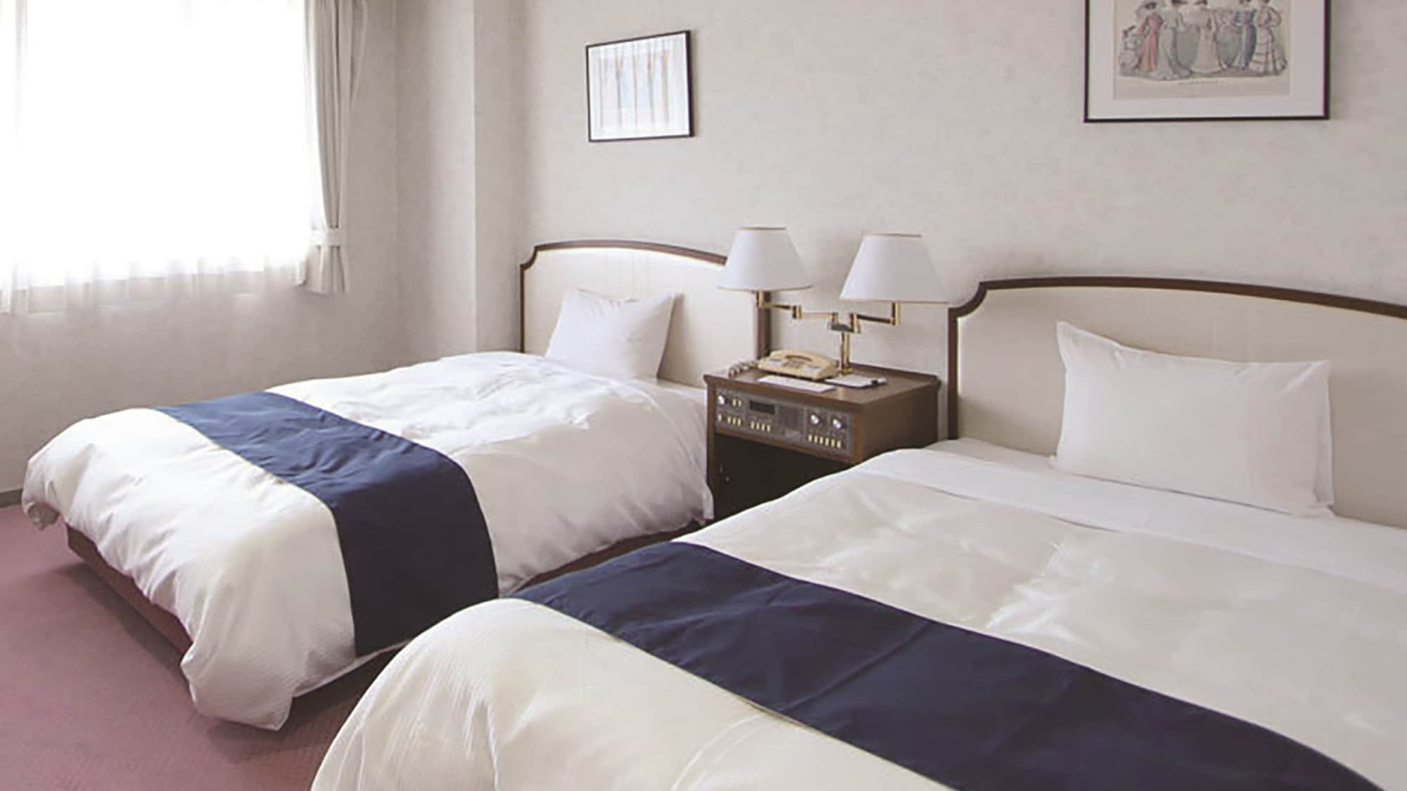 Standard Twin_Gaya selimut khas hotel mengundang Anda untuk tidur nyenyak.