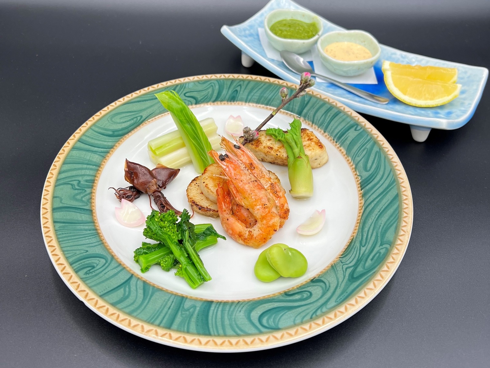 Spring vegetables and seafood grilled in butter with basil sauce