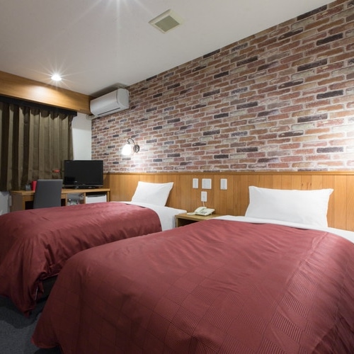 Twin: A very fashionable room with brick wallpaper. Please with your friends and family.