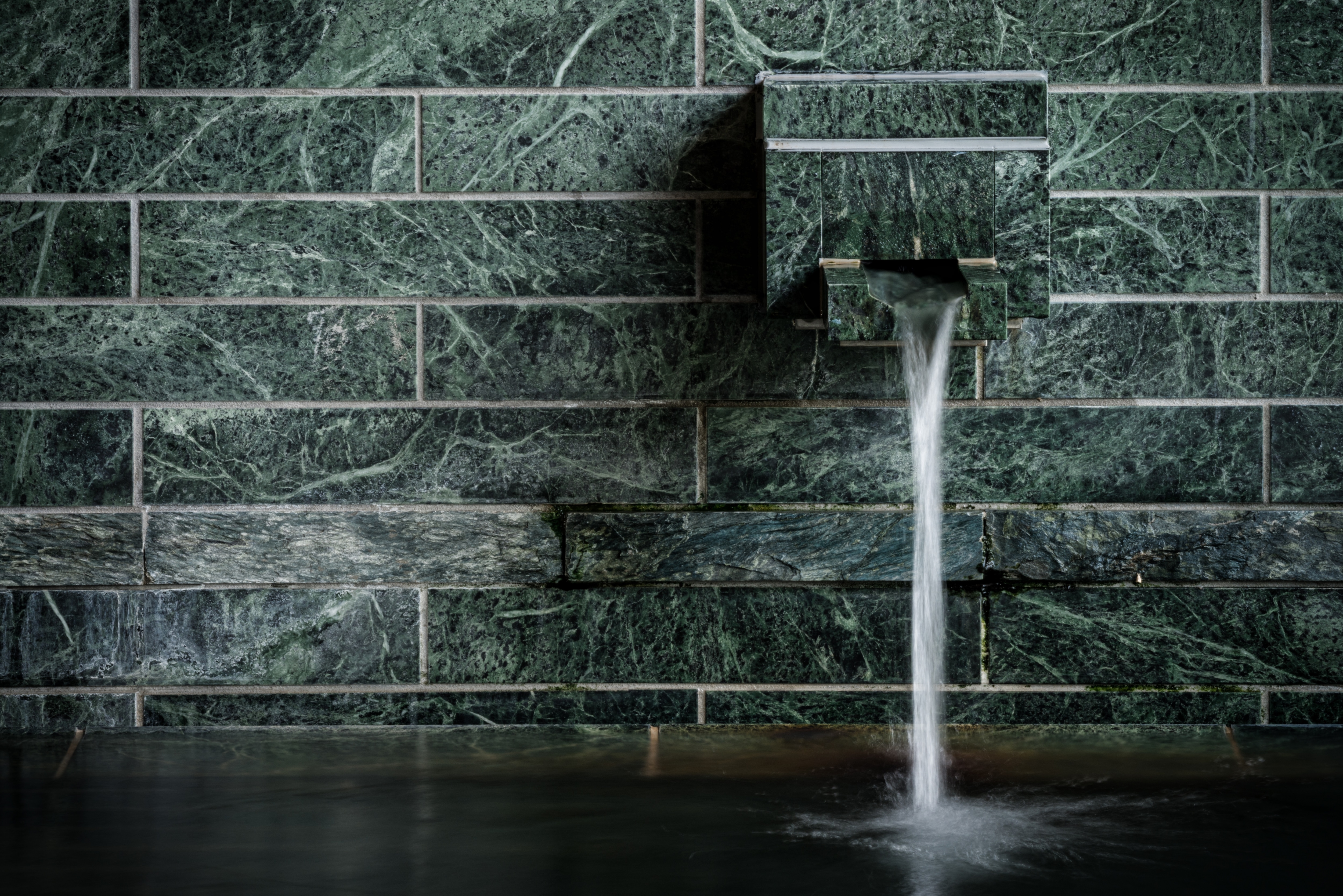 A large bath made with plenty of blue stone