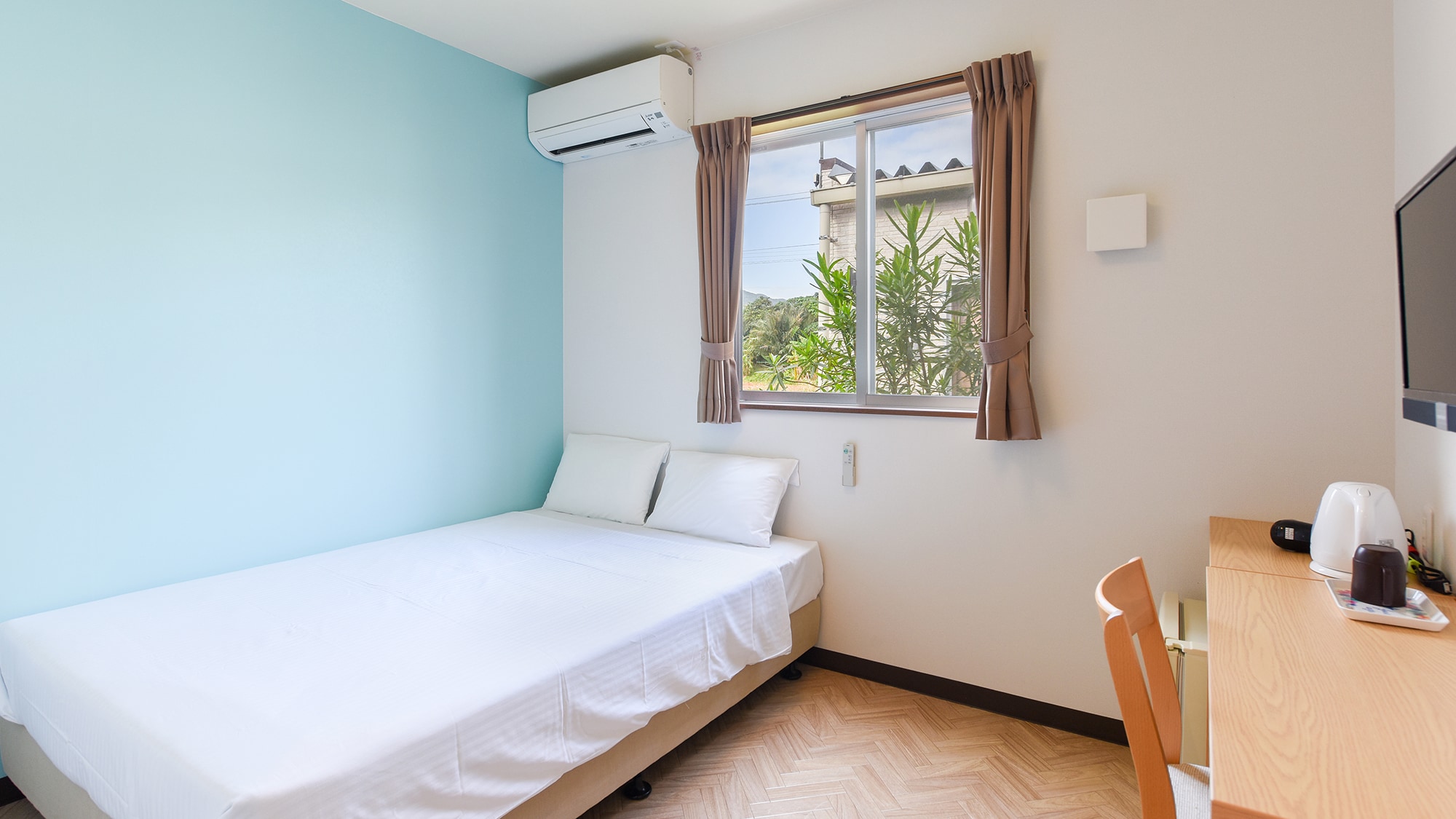 * [Double Room (example)] A spacious bed, recommended for couples.