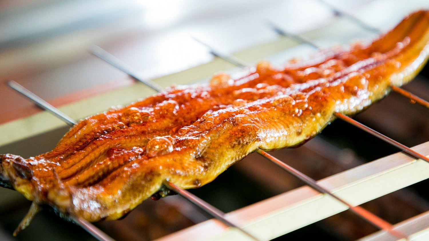 [Image of eel rice bowl preparation] Lake Hamana eel, known for its light, high-quality fat, is grilled in the Kanto style.