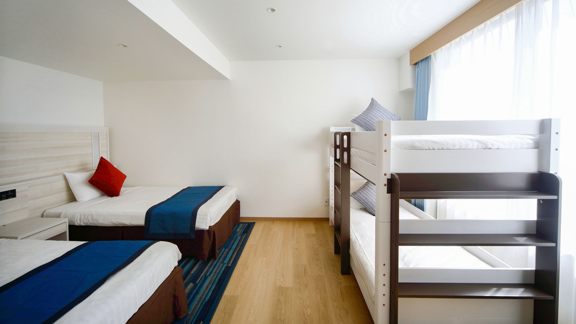[Main Building/Family Room A Type] A bright room with blue accents in wood grain.