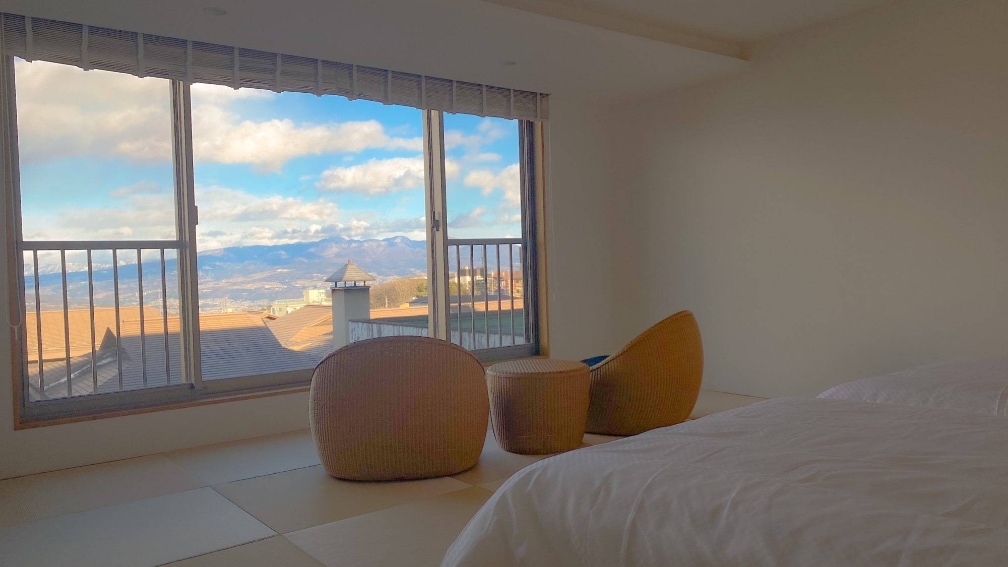 New guest room with bed that emphasizes the view, evening view