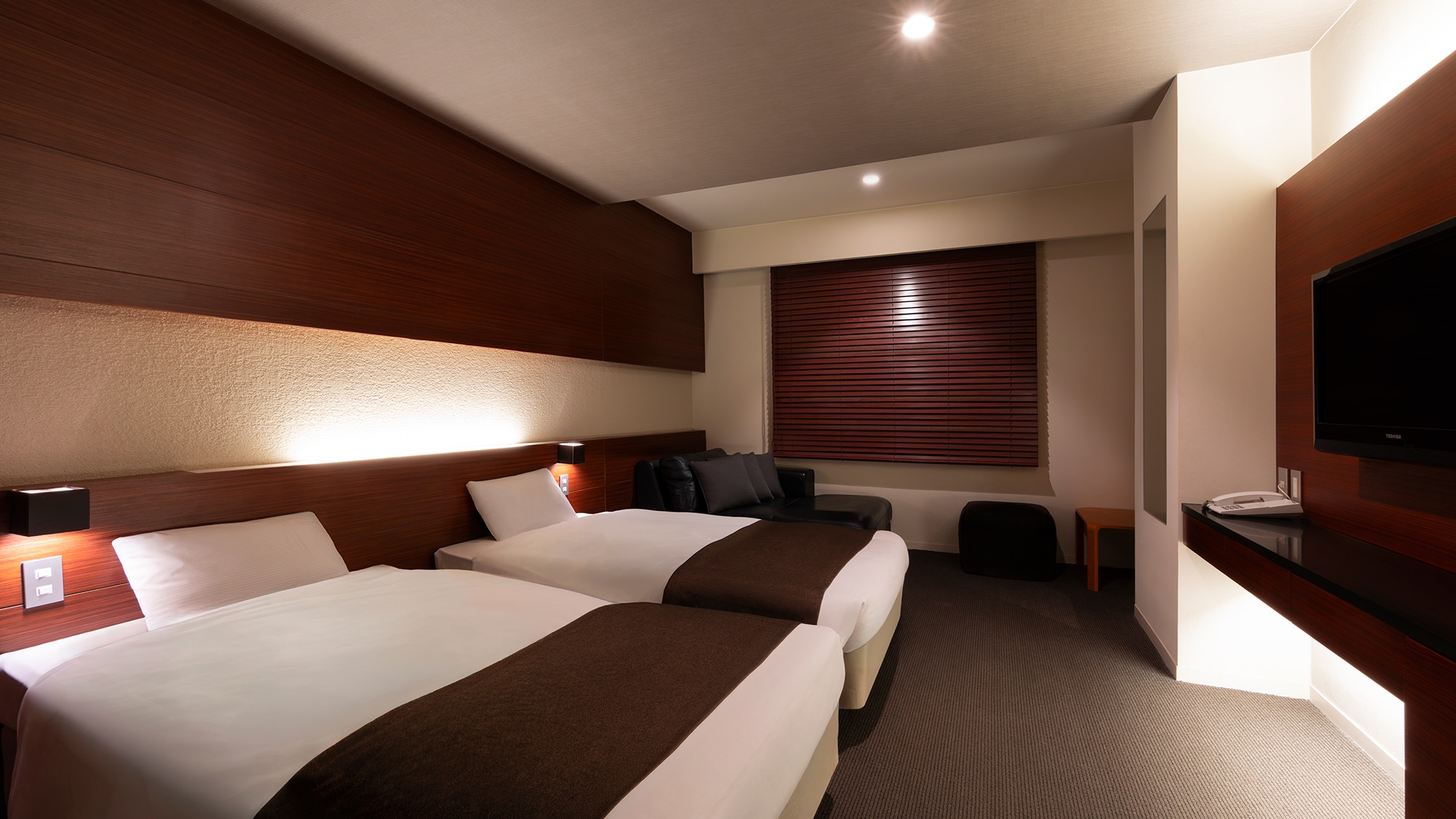 [Western Modern - Nighttime] The guest rooms are decorated in calming colors, creating a sense of luxury.
