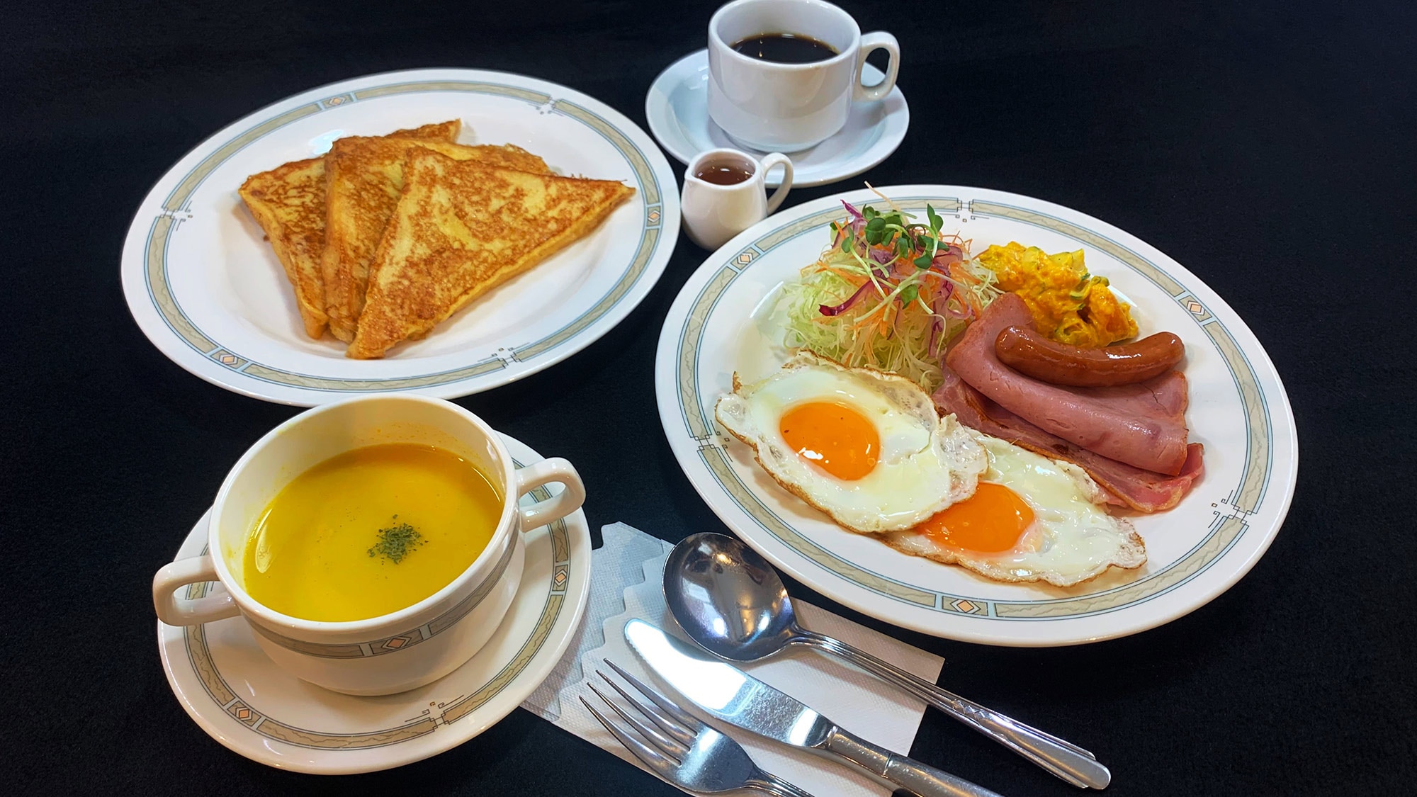 Western breakfast / Popular French toast with fried egg, bacon, soup and drink.