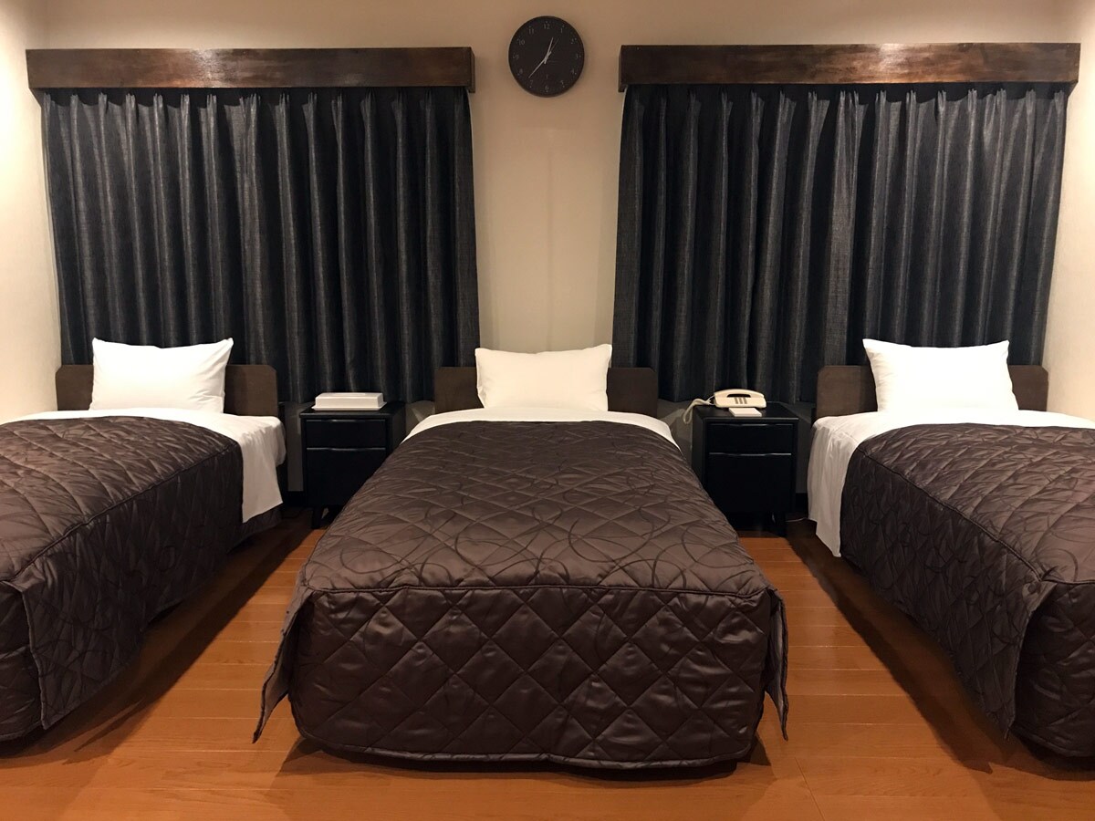 [Interior of triple room] A modern room with calming colors.