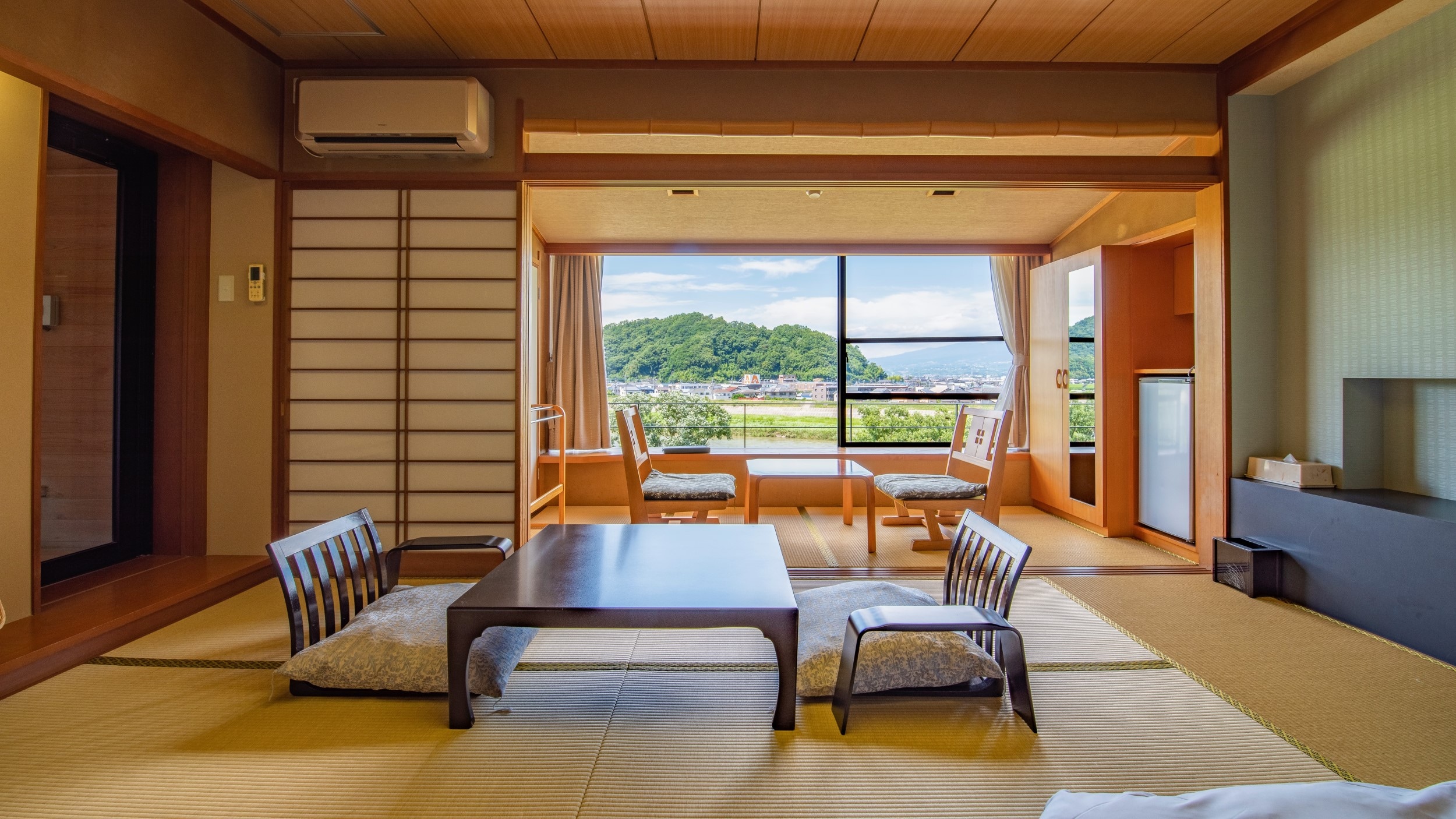 Standard Japanese-style room with a view of Mt. Fuji and the mountains from the window
