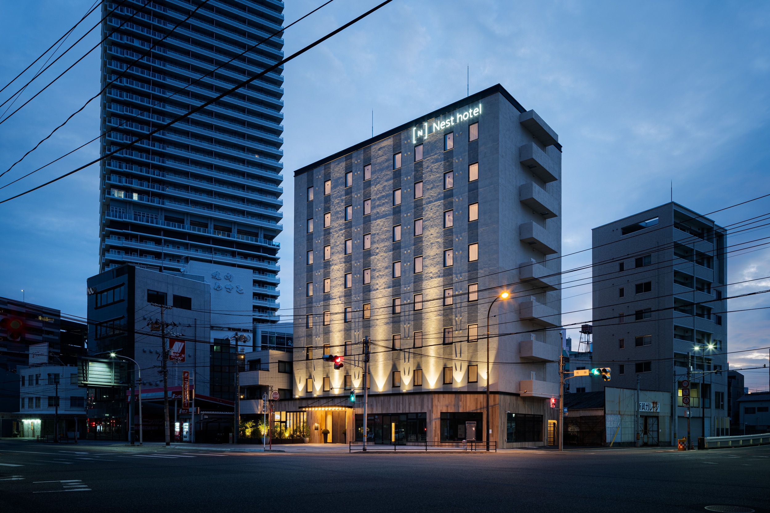 Hotel exterior A hotel located near the station. It is lit up at night, creating a simple yet strong presence.