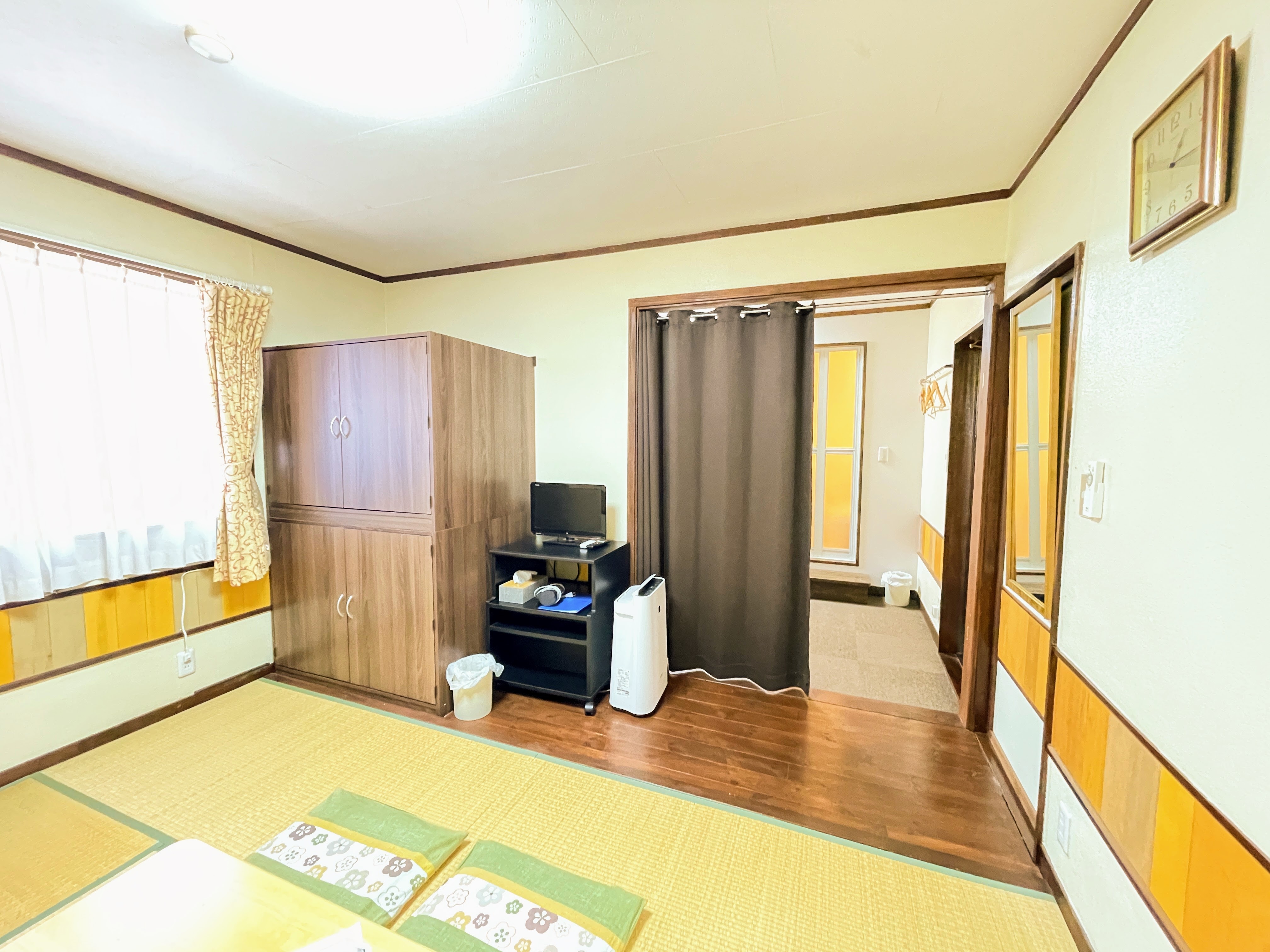 Two-room Japanese-Western style room with half-closed curtains