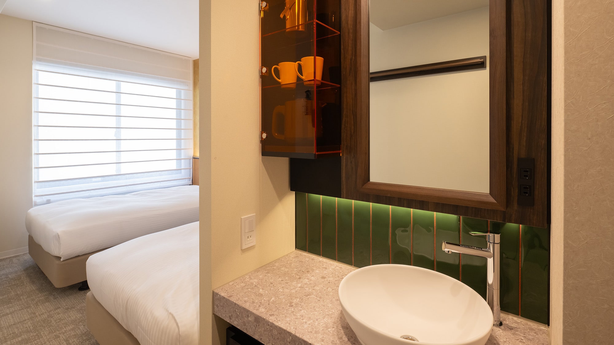 [Bathroom] The washbasin is separate from the toilet and shower booth, making it comfortable for two guests.