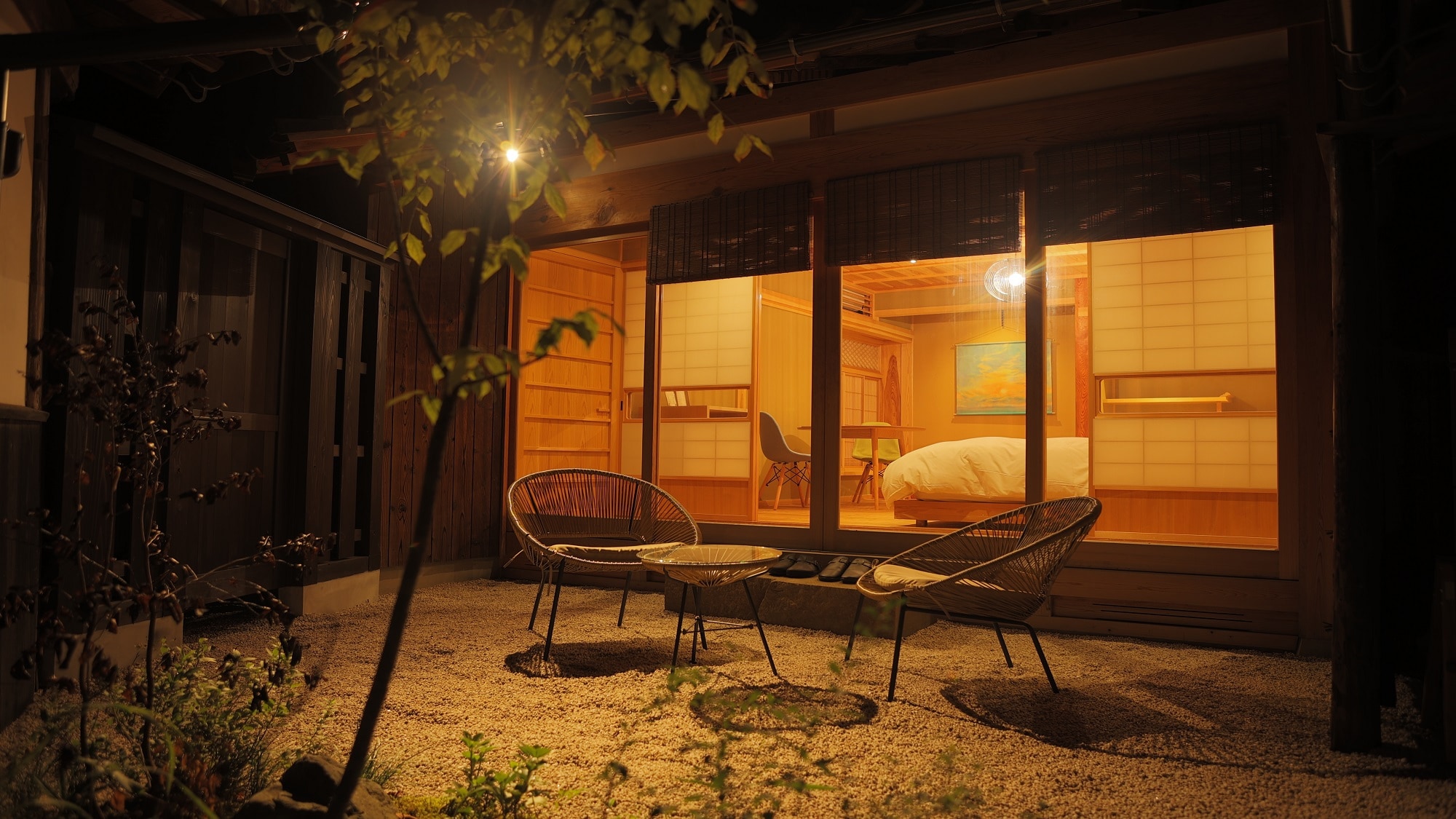 There is a small garden with a garden table.