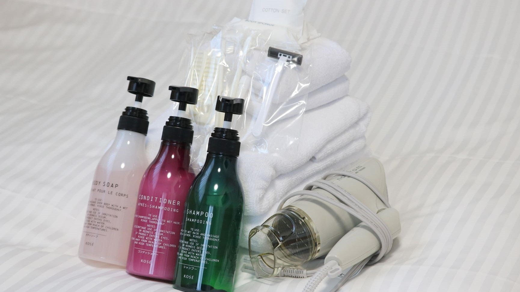 Shampoo and other bathroom amenities, toothbrush set, razor, cotton set, and hair dryer are provided.