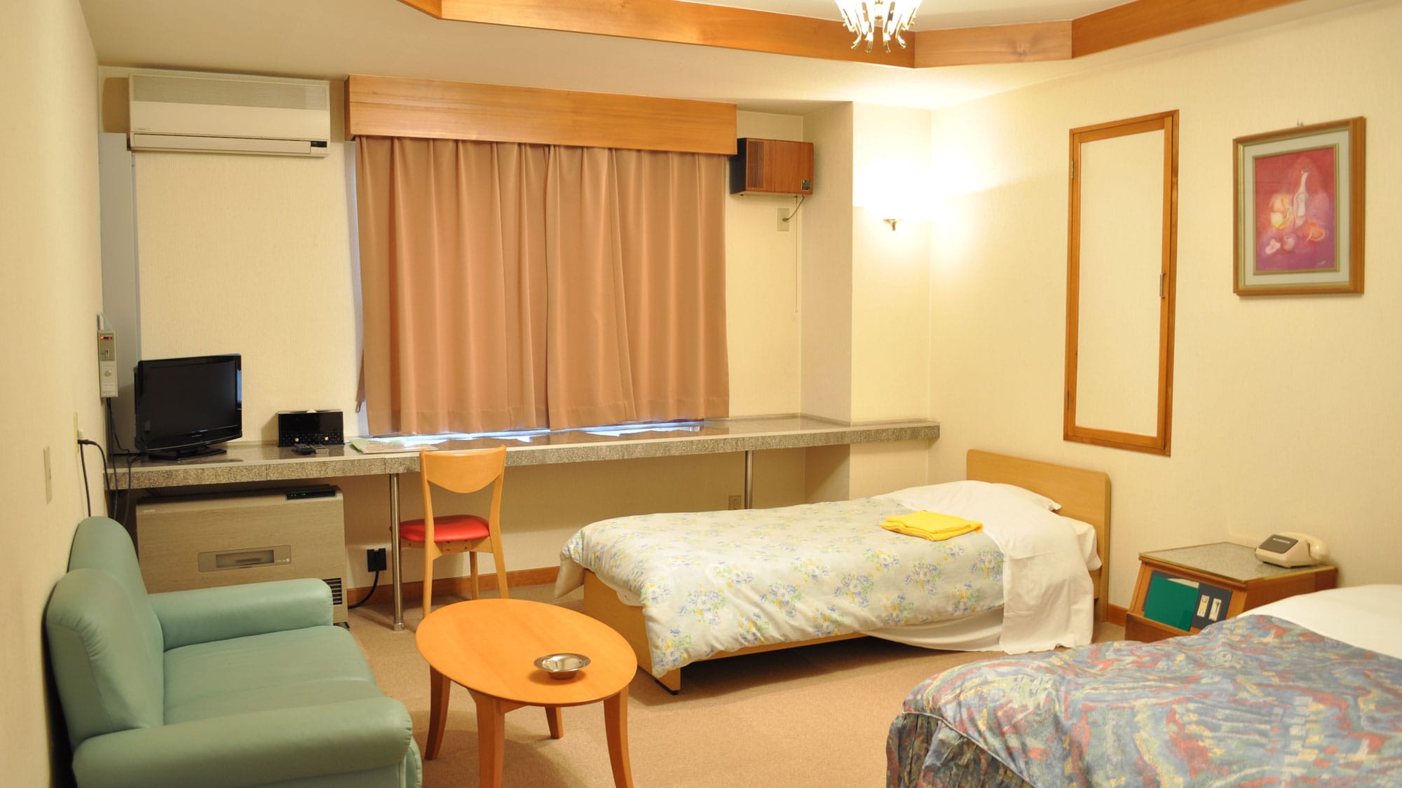 [Family Room] This room is equipped with a double bed and a single bed, perfect for families with children.