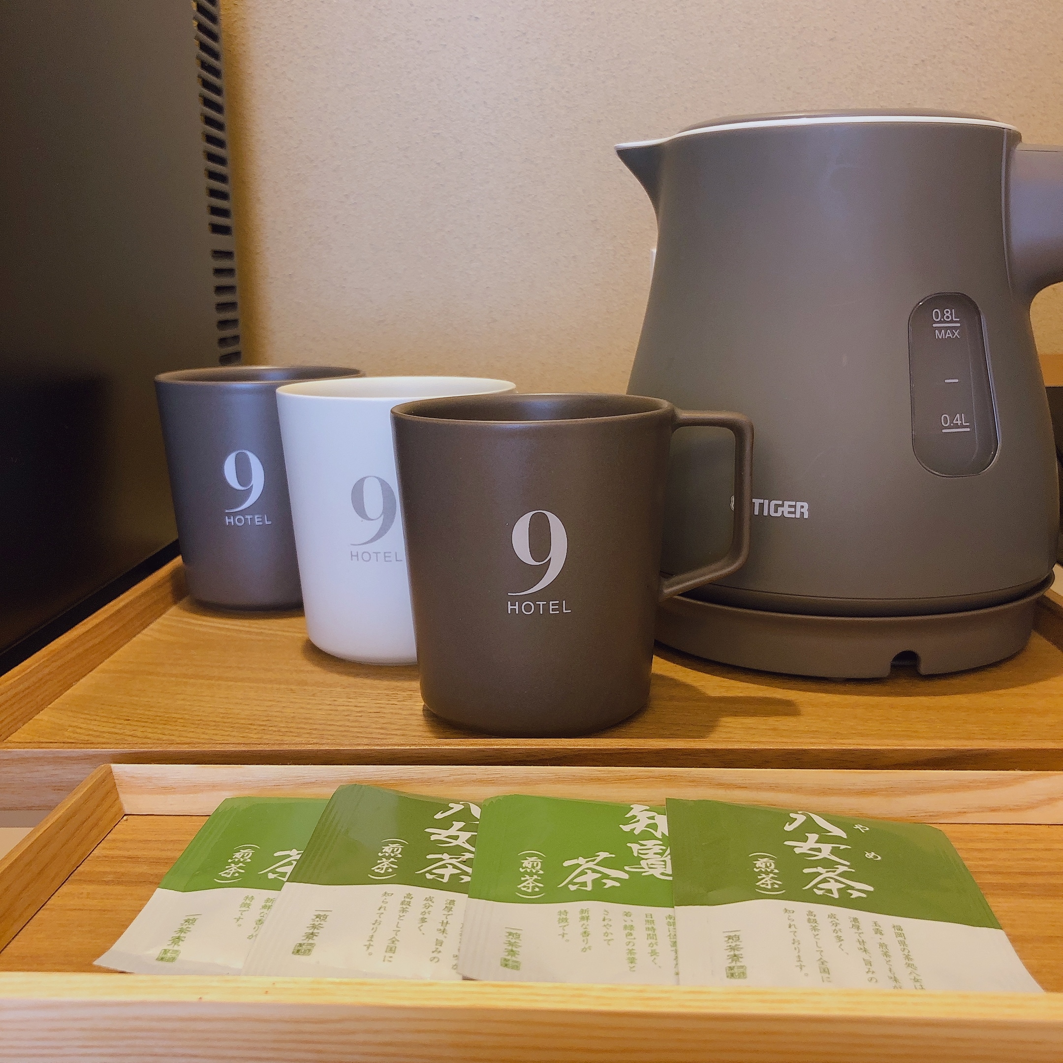 A kettle and green tea bag are available in the room