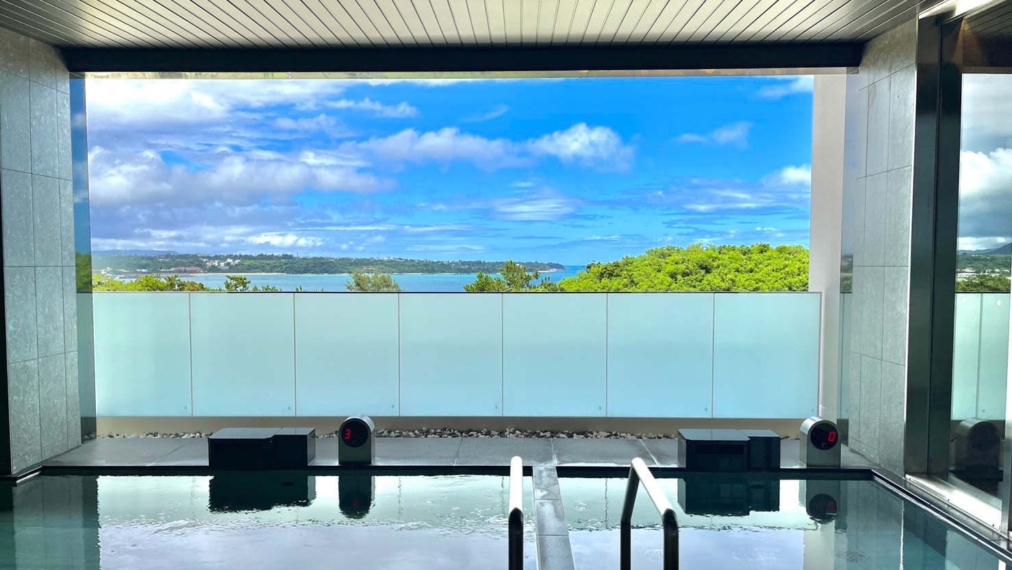 Enjoy the slow flow of time as you gaze out at the ocean from the hot springs