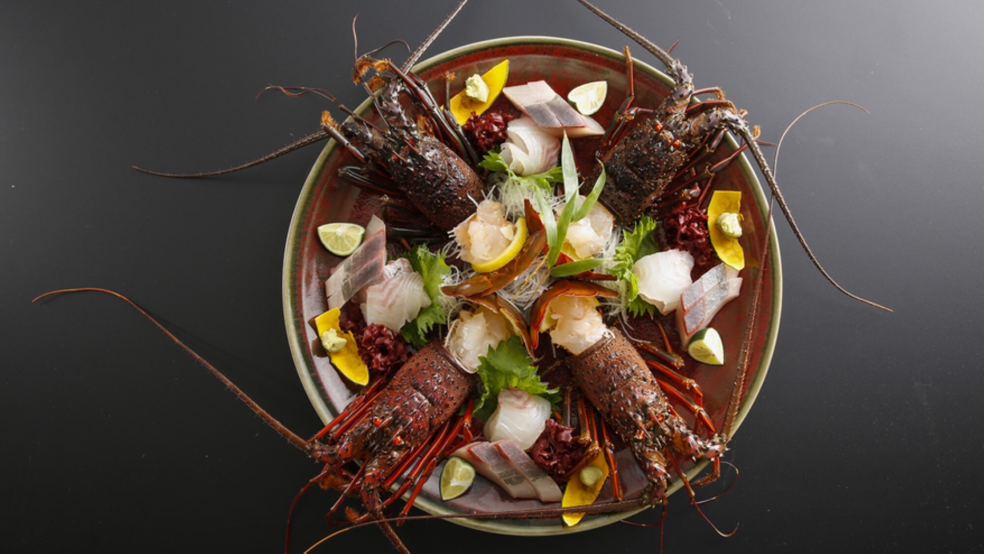 Fresh spiny lobster, sea bream, and yellowtail sashimi. The photo shows a serving for four.