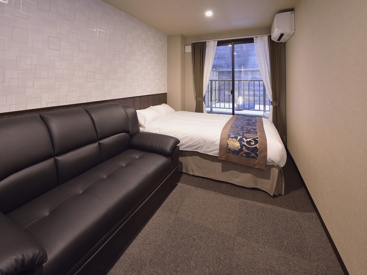 A room with 1 double bed and 1 sofa bed. Suitable for 2-3 adults.