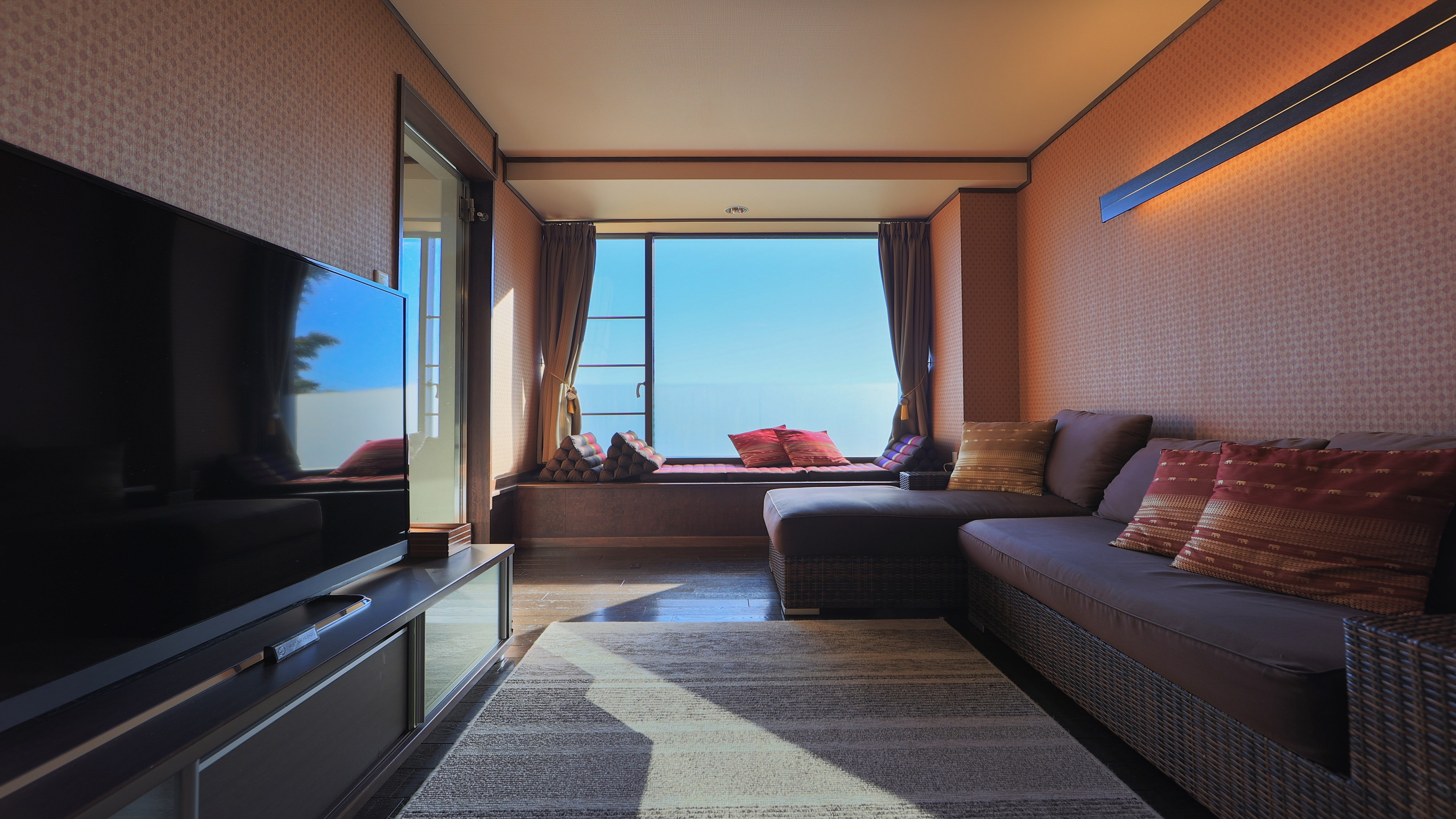 Bali room with natural hot spring overlooking the sea and living room with Bali interior