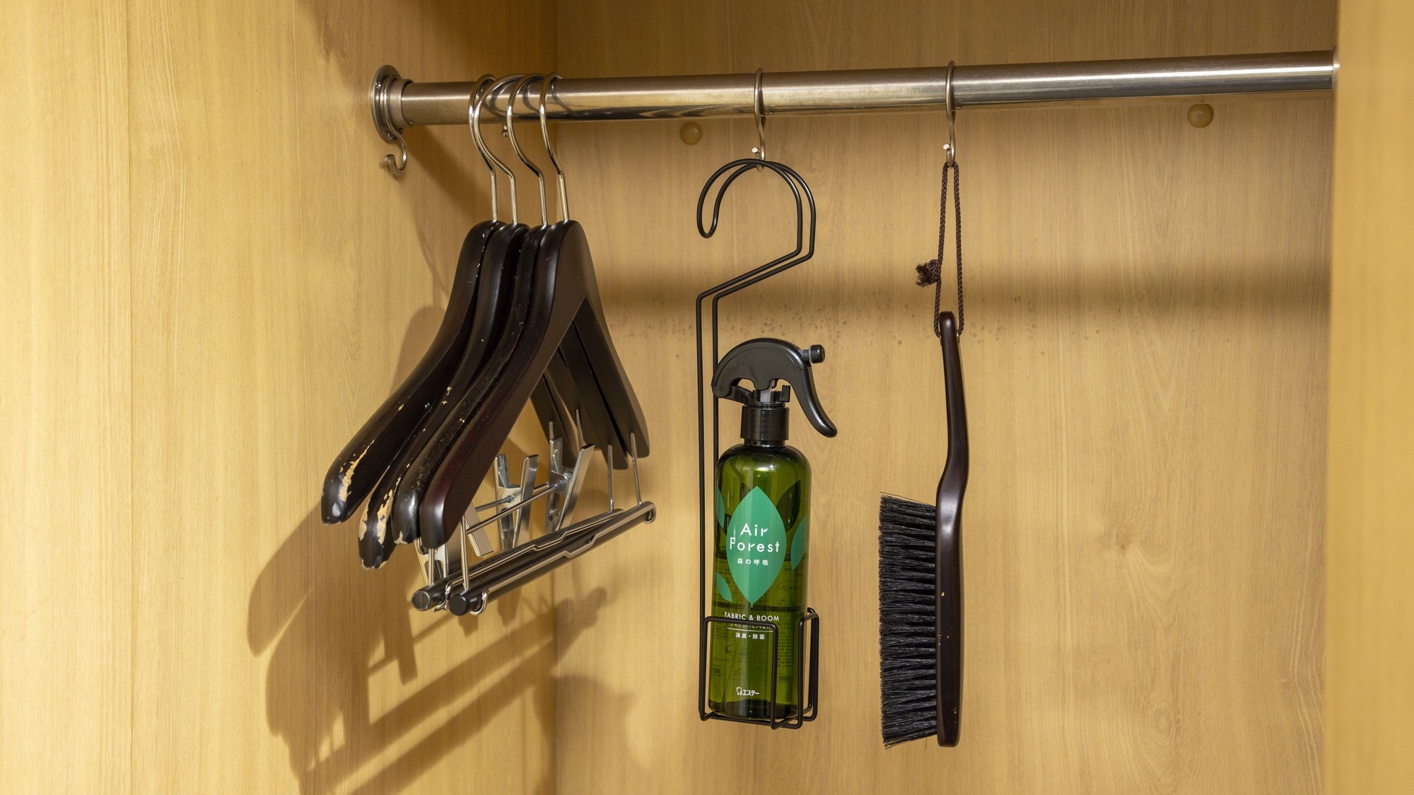 Hangers, deodorizers, and brushes are provided in the room.