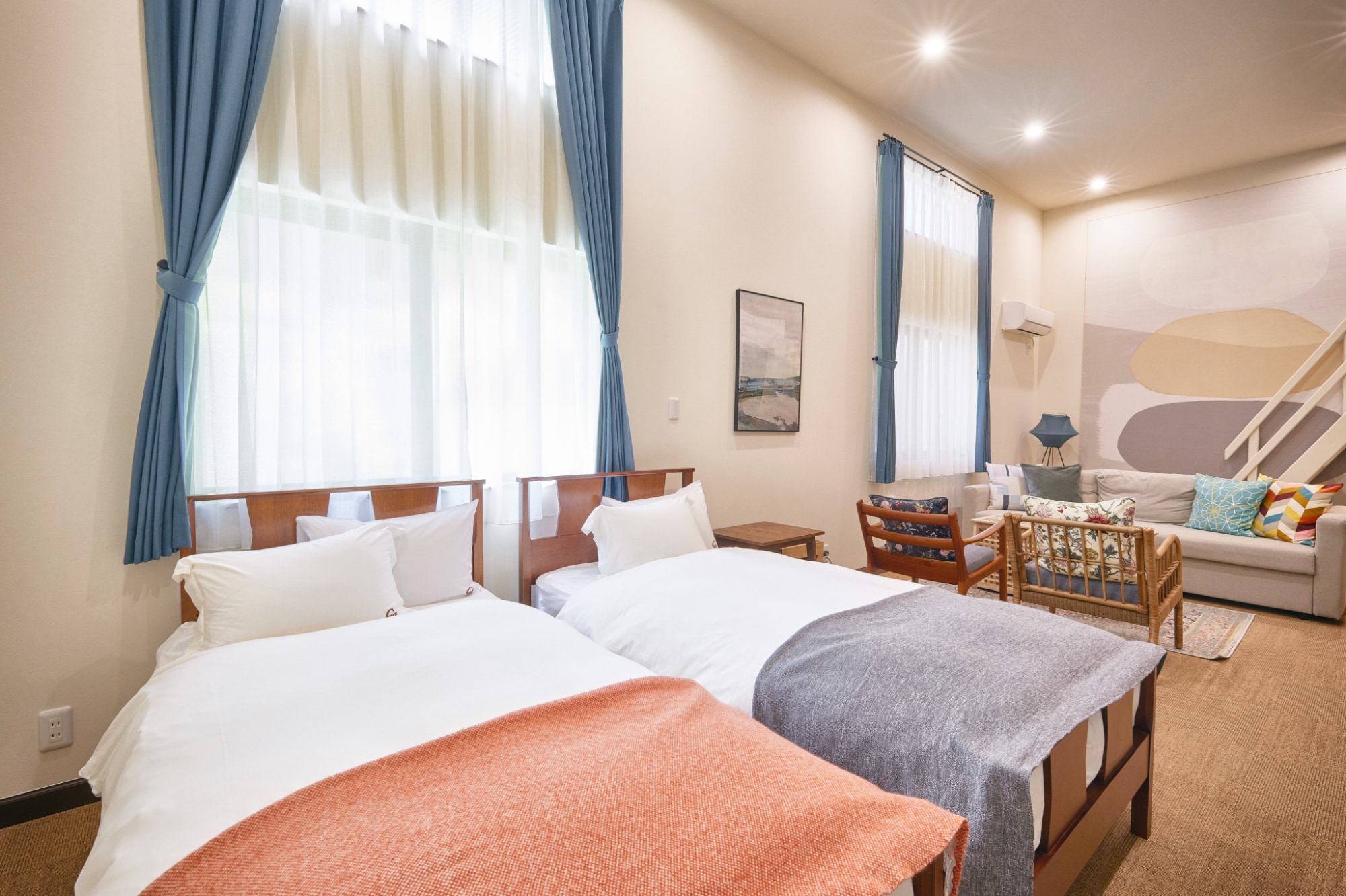 There are also two single beds on the floor, so those who don't like the loft can use them.