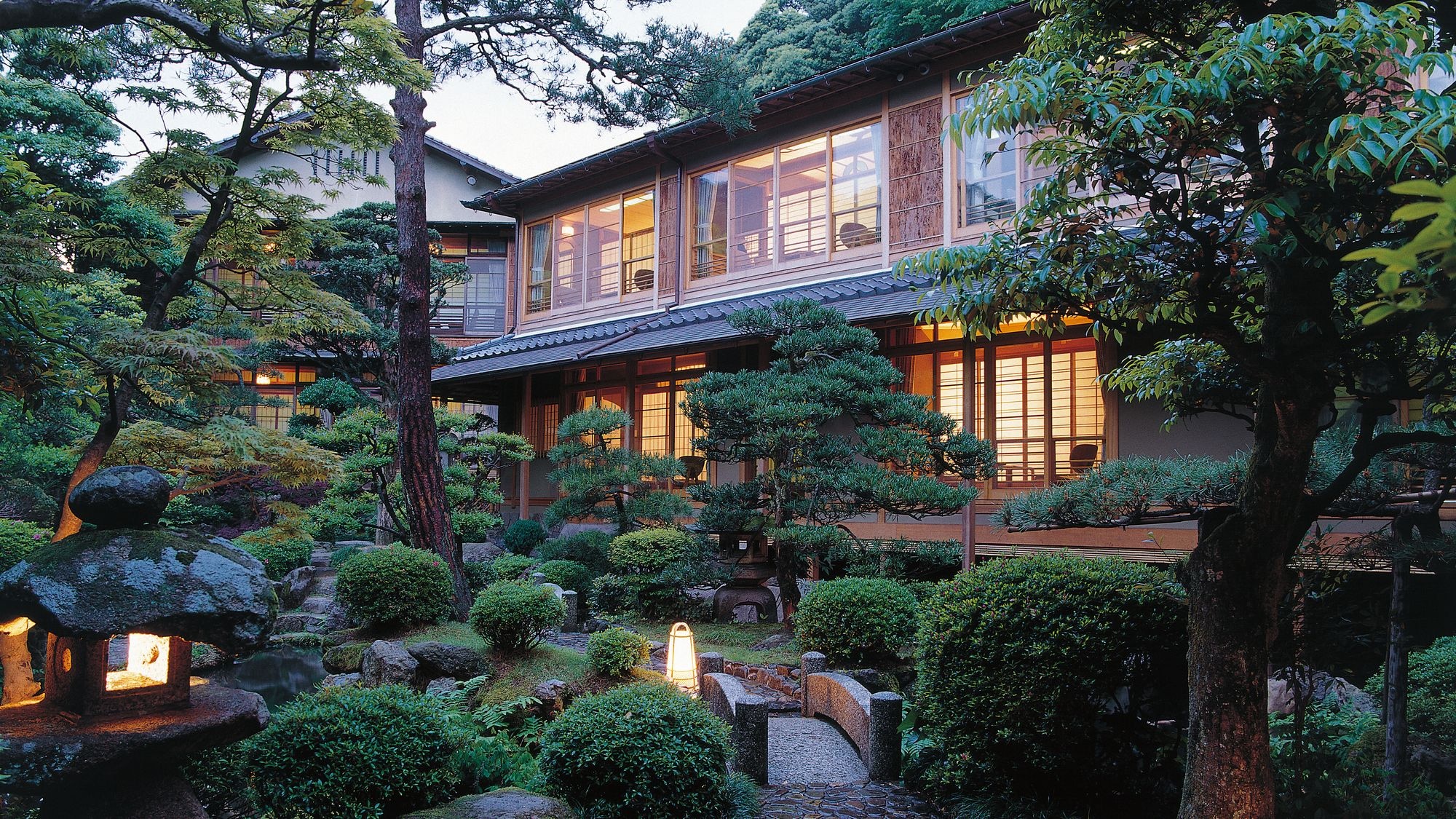 A stunning Japanese garden with a stream and a pond where carps swim
