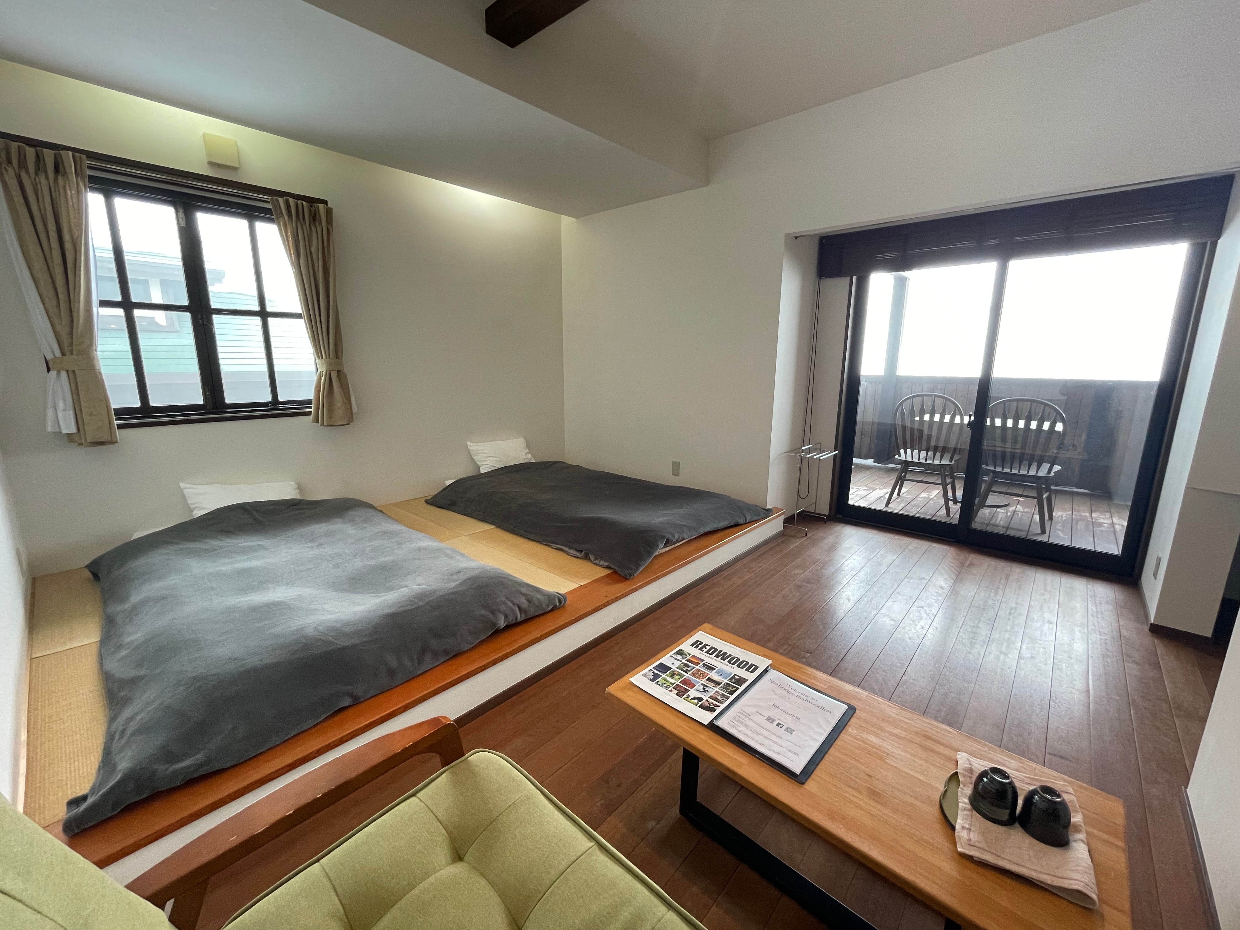 A 10-tatami Japanese-Western style room with a toilet and a terrace overlooking the ranch