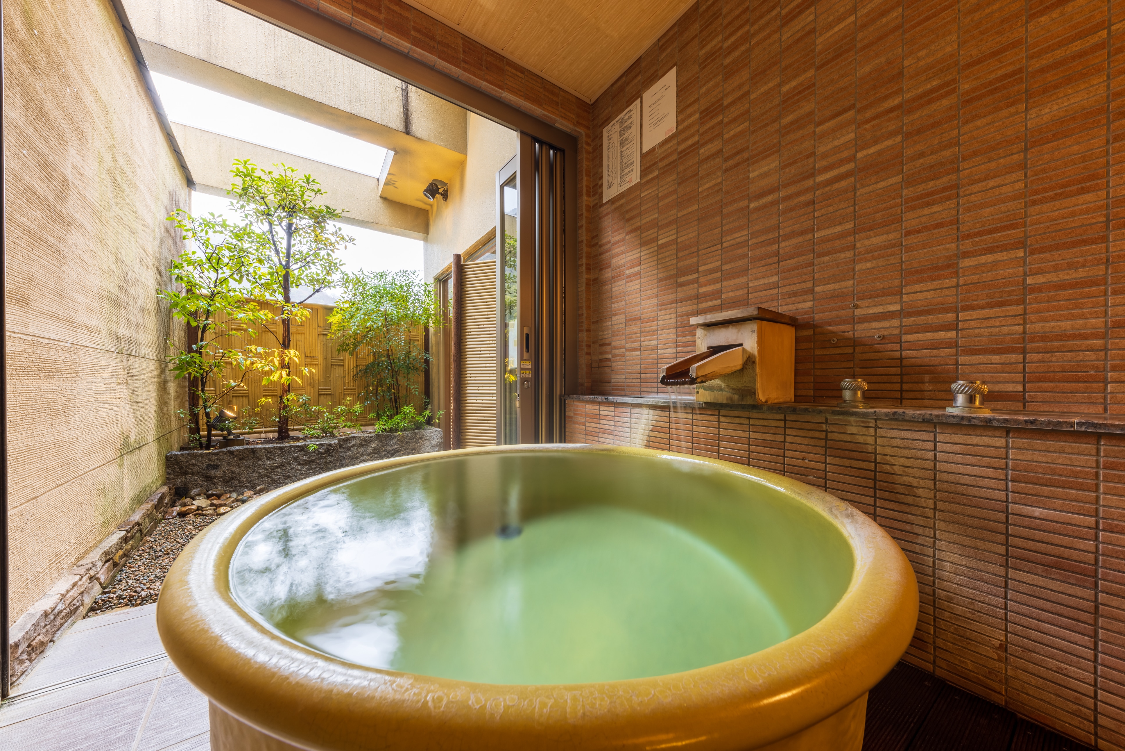 [Town side] Example of a Japanese-Western style room with a free-flowing open-air bath (ceramic bowl-shaped)