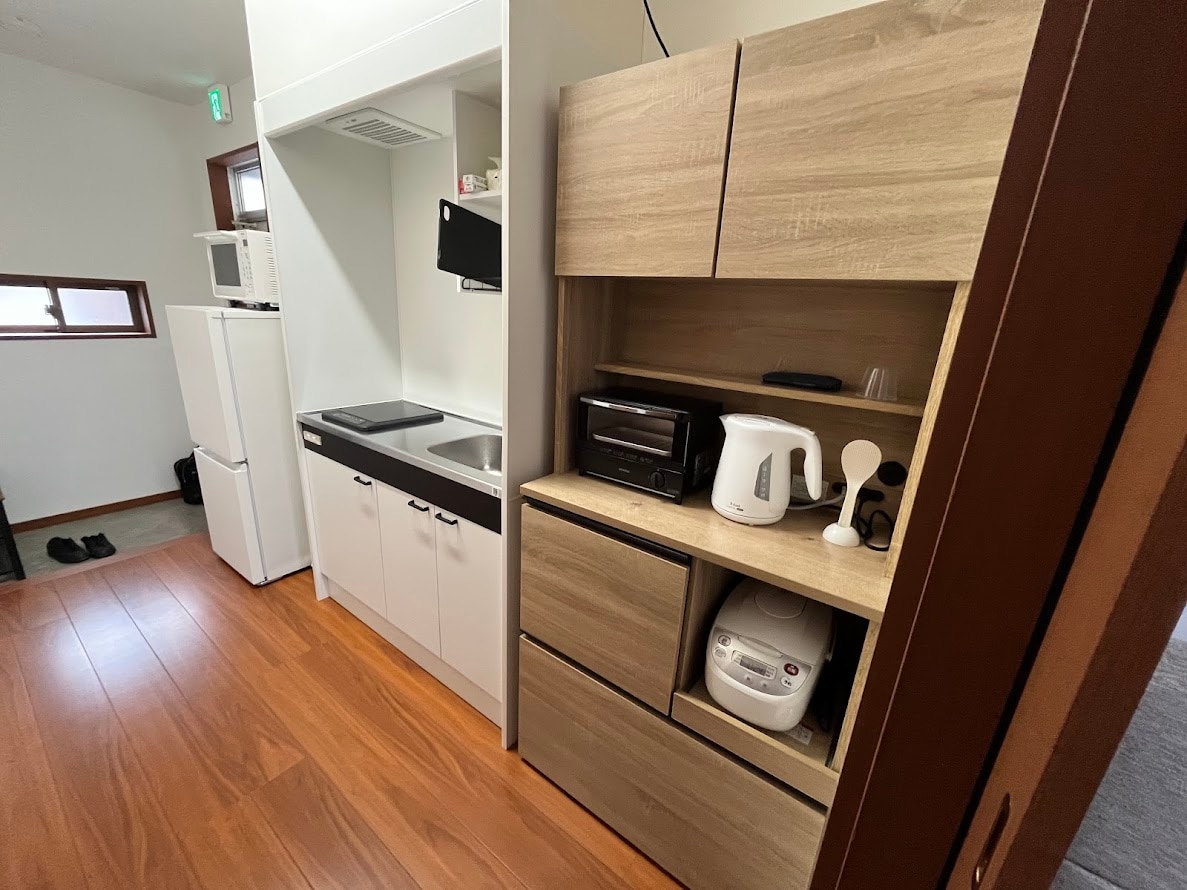 Refrigerator, mini kitchen, kitchen cabinet (Room 201)