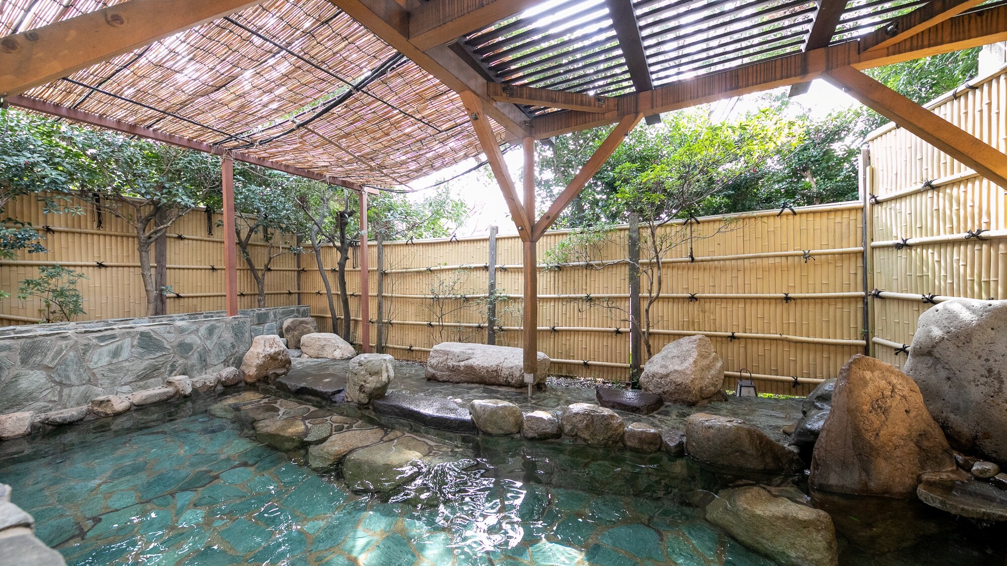 Men's Bath [Open-air bath] An open-air bath bathed in the natural breeze and sunlight filtering through the trees.