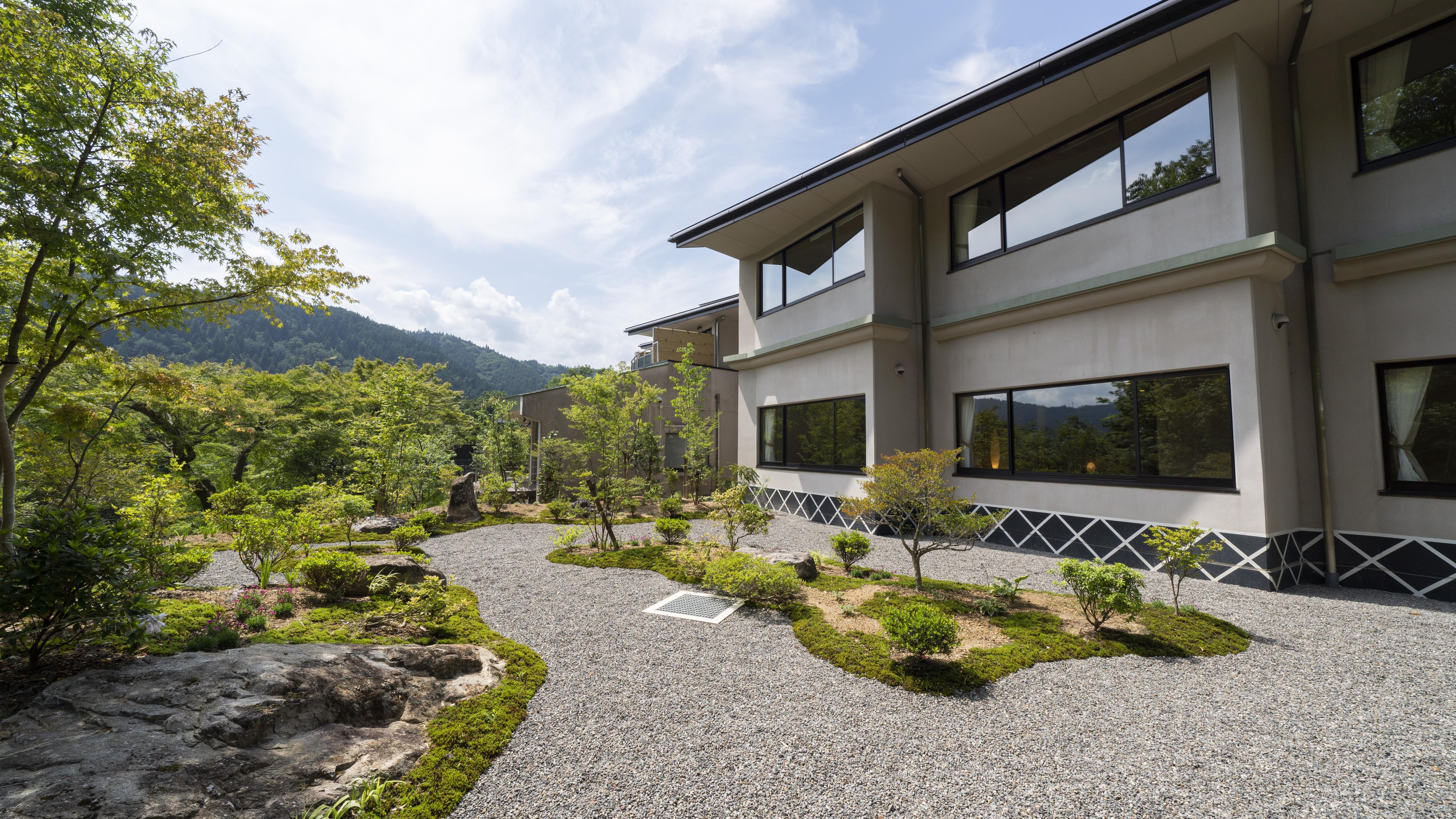 Seasonal flowers bloom in the garden in front of the deluxe room