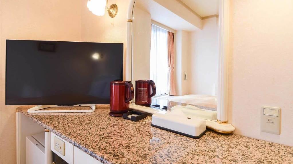 [Double] Work progresses at a luxurious desk made of granite.