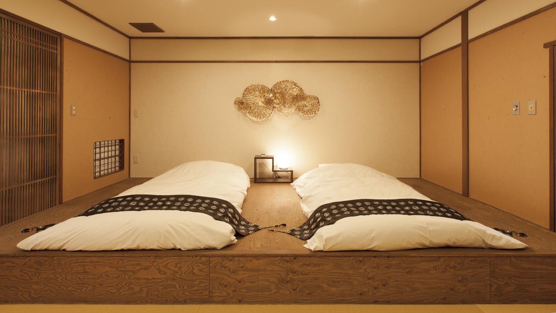 A modern Japanese room with a futon on the raised floor