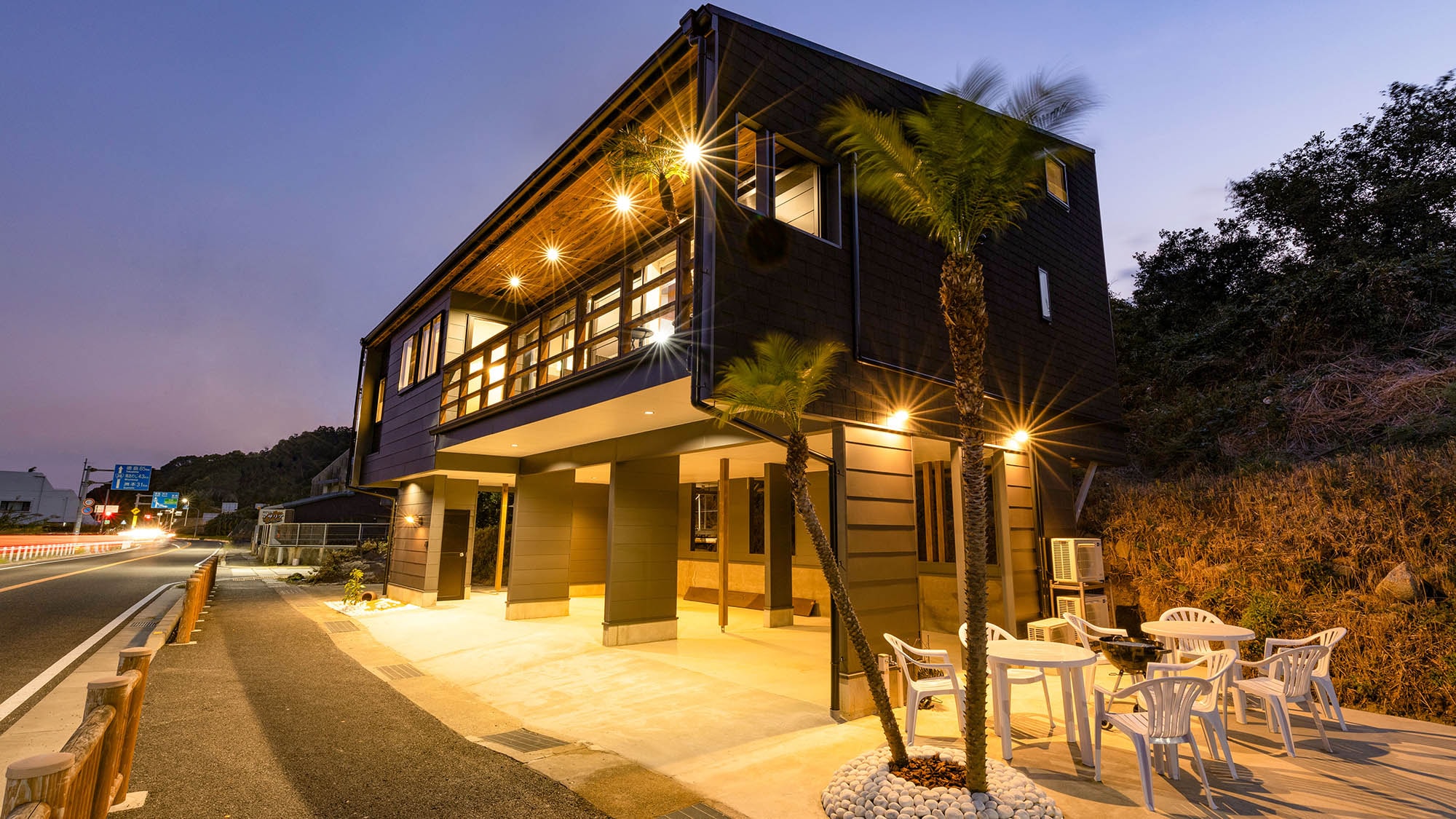 ・Exterior (night): A seaside vacation home with a tropical atmosphere