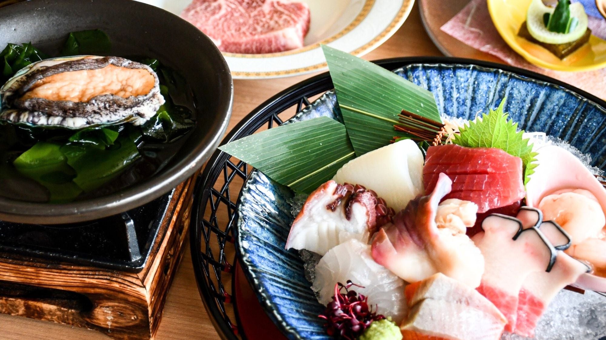Enjoy a luxurious dinner that includes a sashimi platter, abalone, and beef steak.