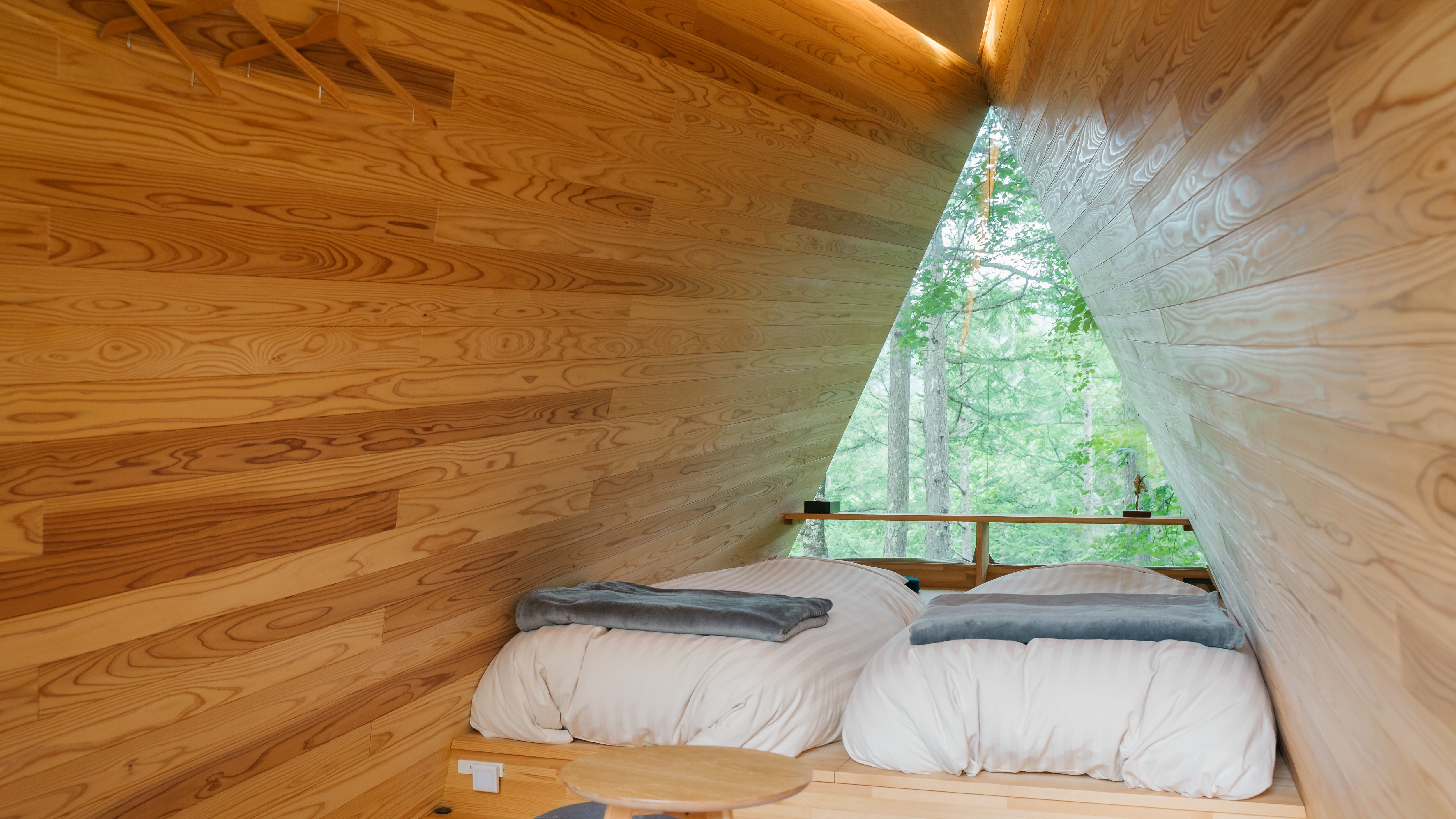 The distinctive triangular windows overlook the Azumino forest.