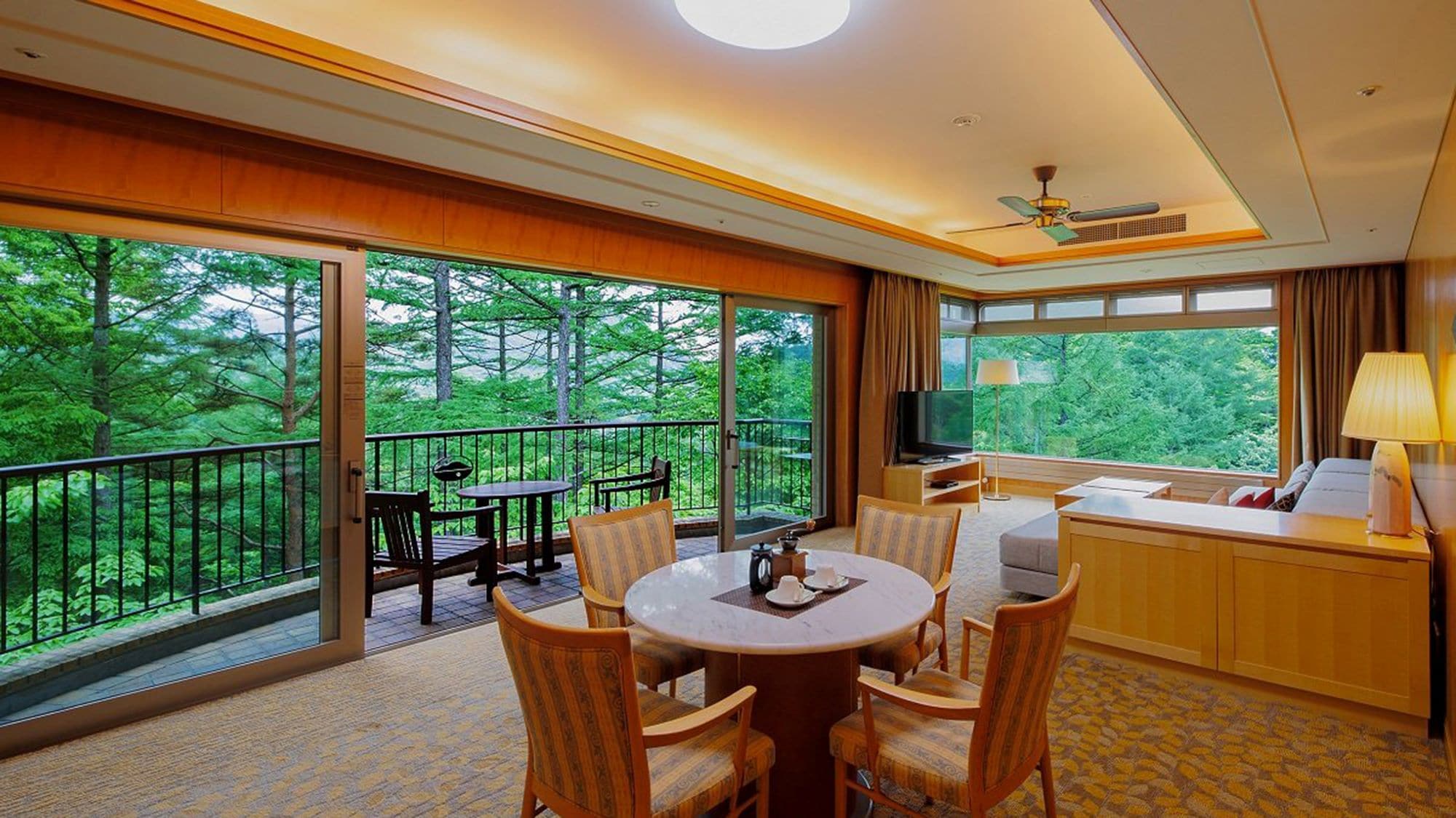 Suite room: Spacious living room. Feel the nature of Karuizawa in the open space with two glass walls.